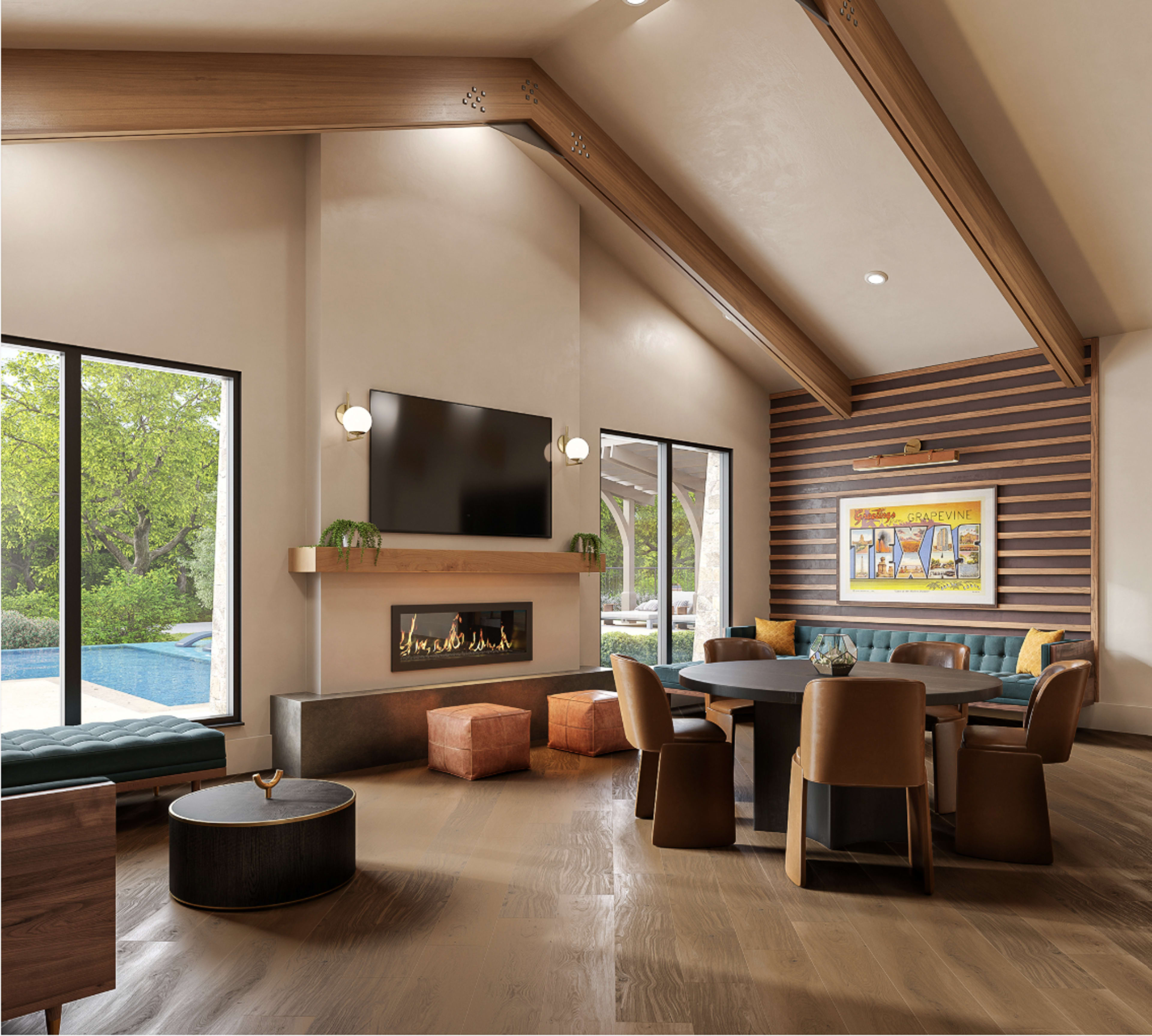 The image shows a modern living space with large windows, a fireplace, and a dining table surrounded by chairs, complemented by colorful ottomans and a view of the outdoors.