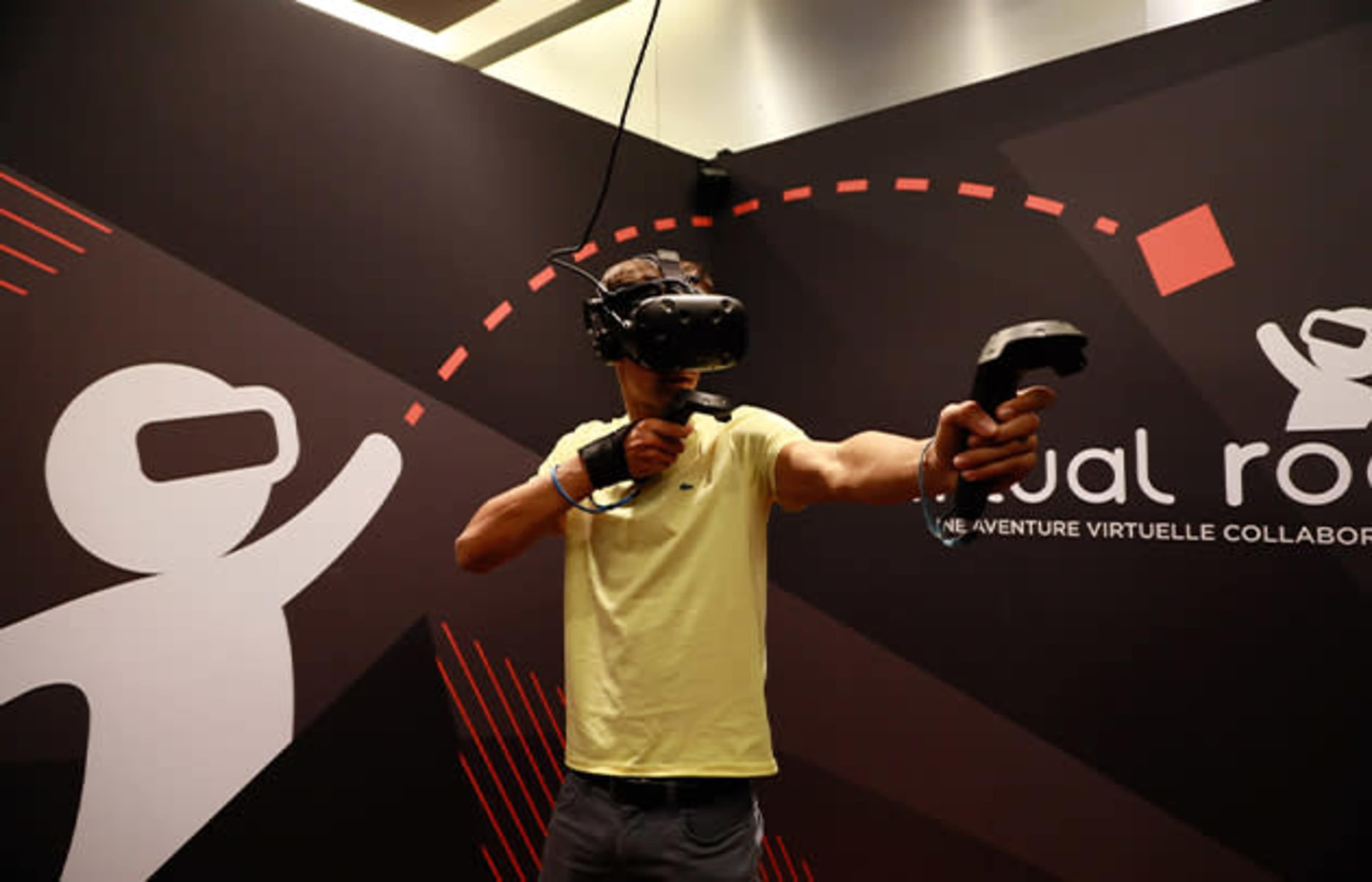 A person wearing a virtual reality headset is aiming with a controller in a themed VR environment.