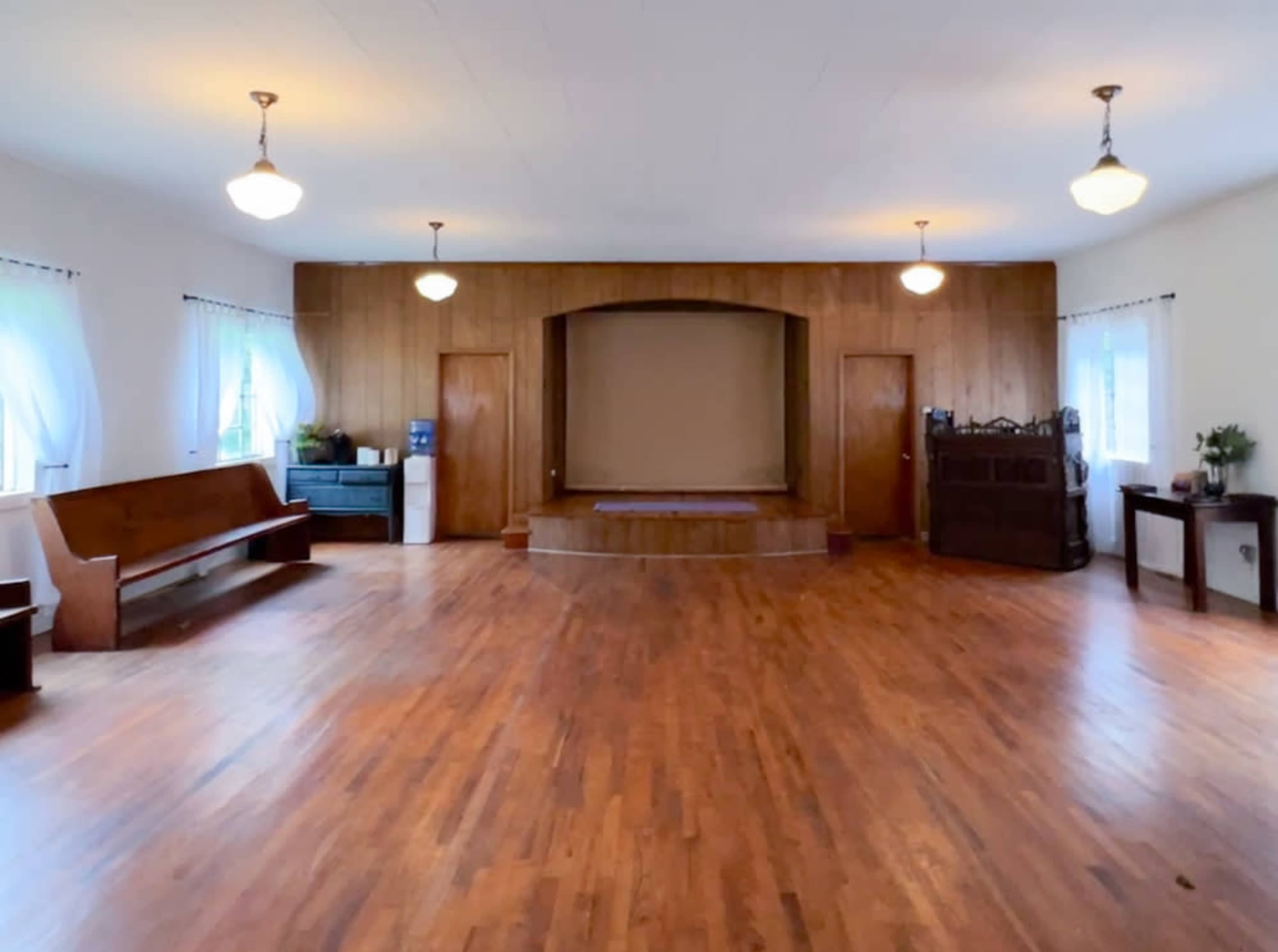 The Studio at Valle View ~ simple old church building with lots of natural light, a stage and pews, rural area Image in , Banner Elk, NC