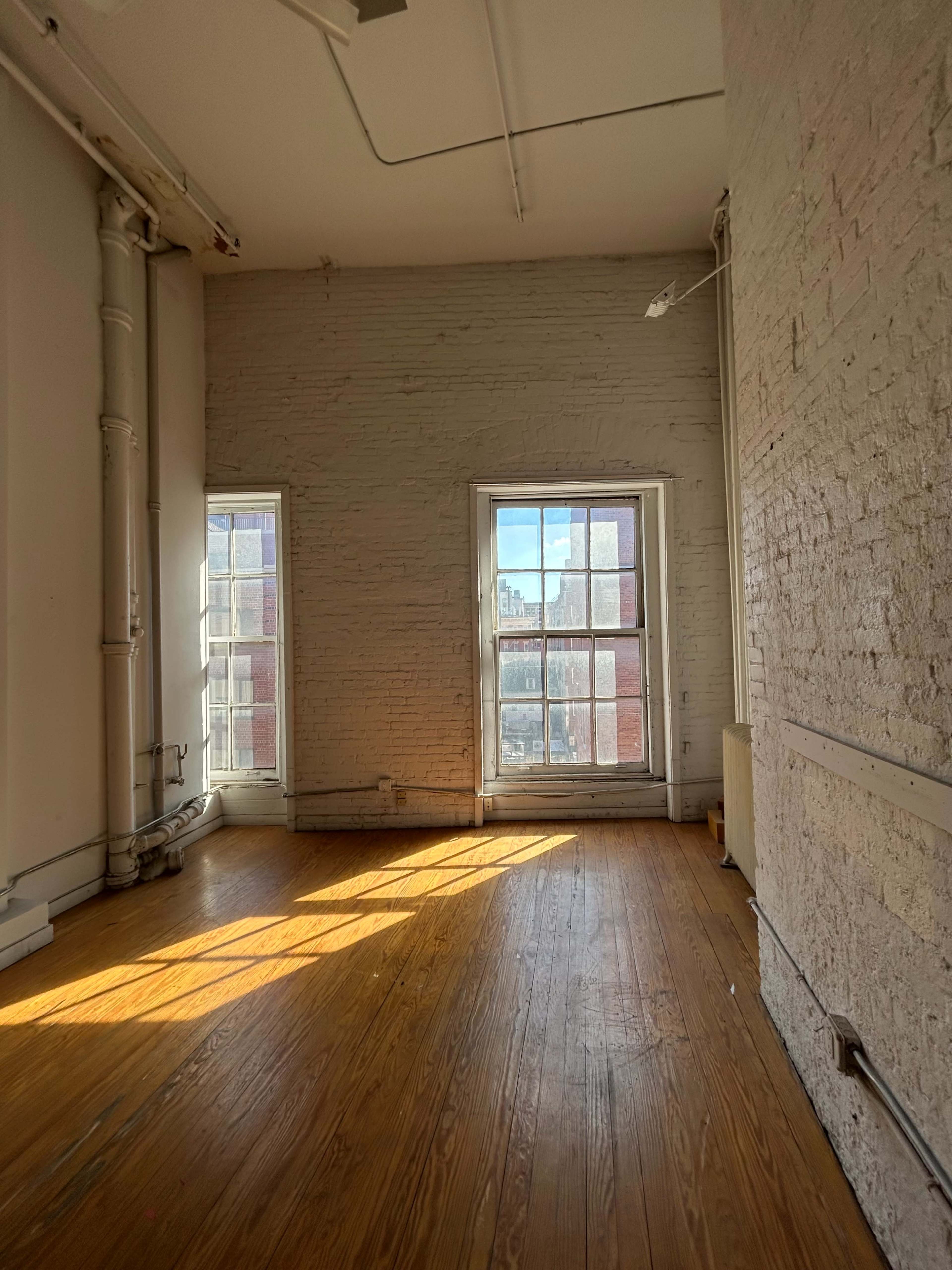 Soho Loft with High Ceilings and White Brick Walls Image in Little Italy, New York, NY
