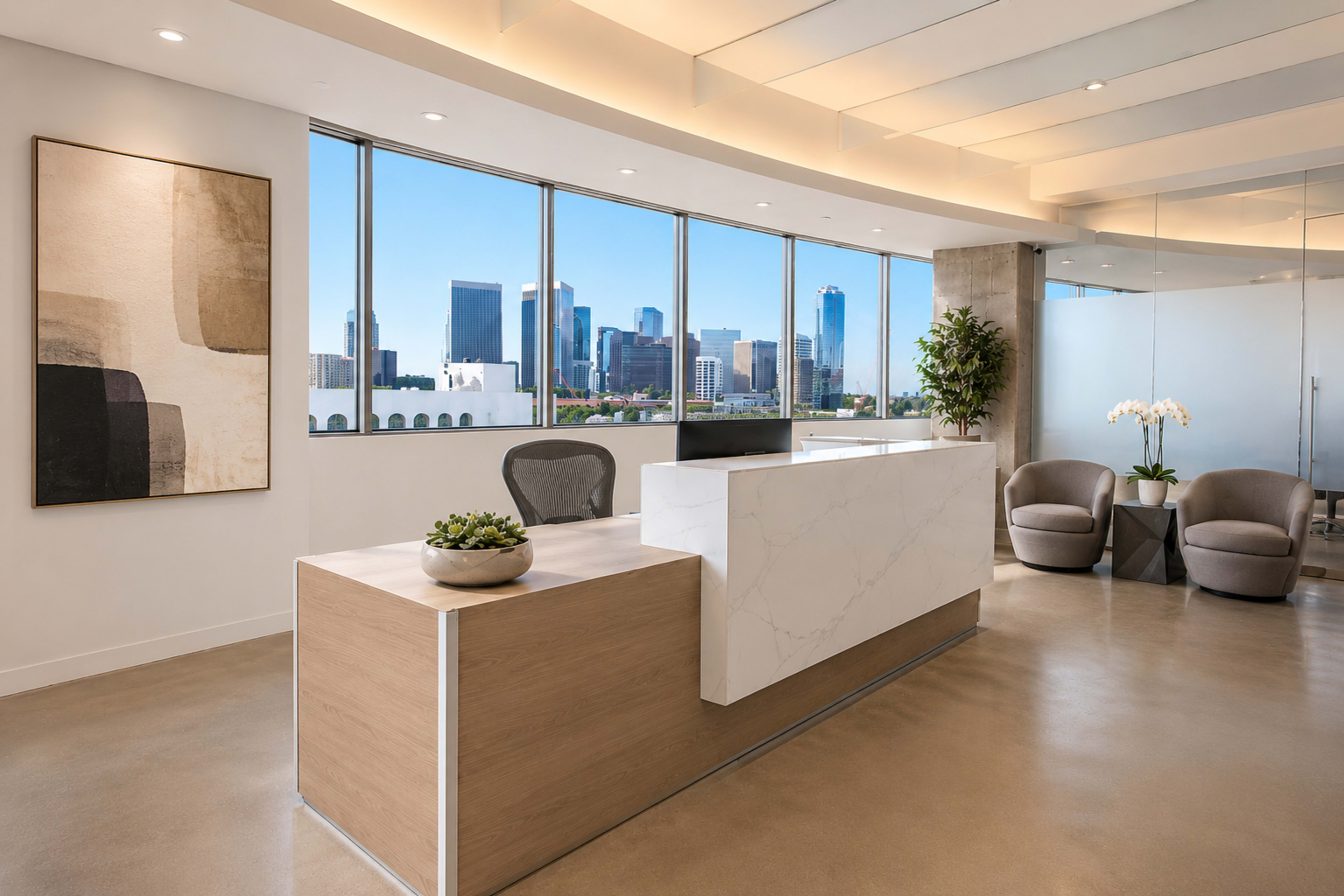 A modern office reception area features a marble-front desk, stylish seating, and large windows offering a view of the city skyline.