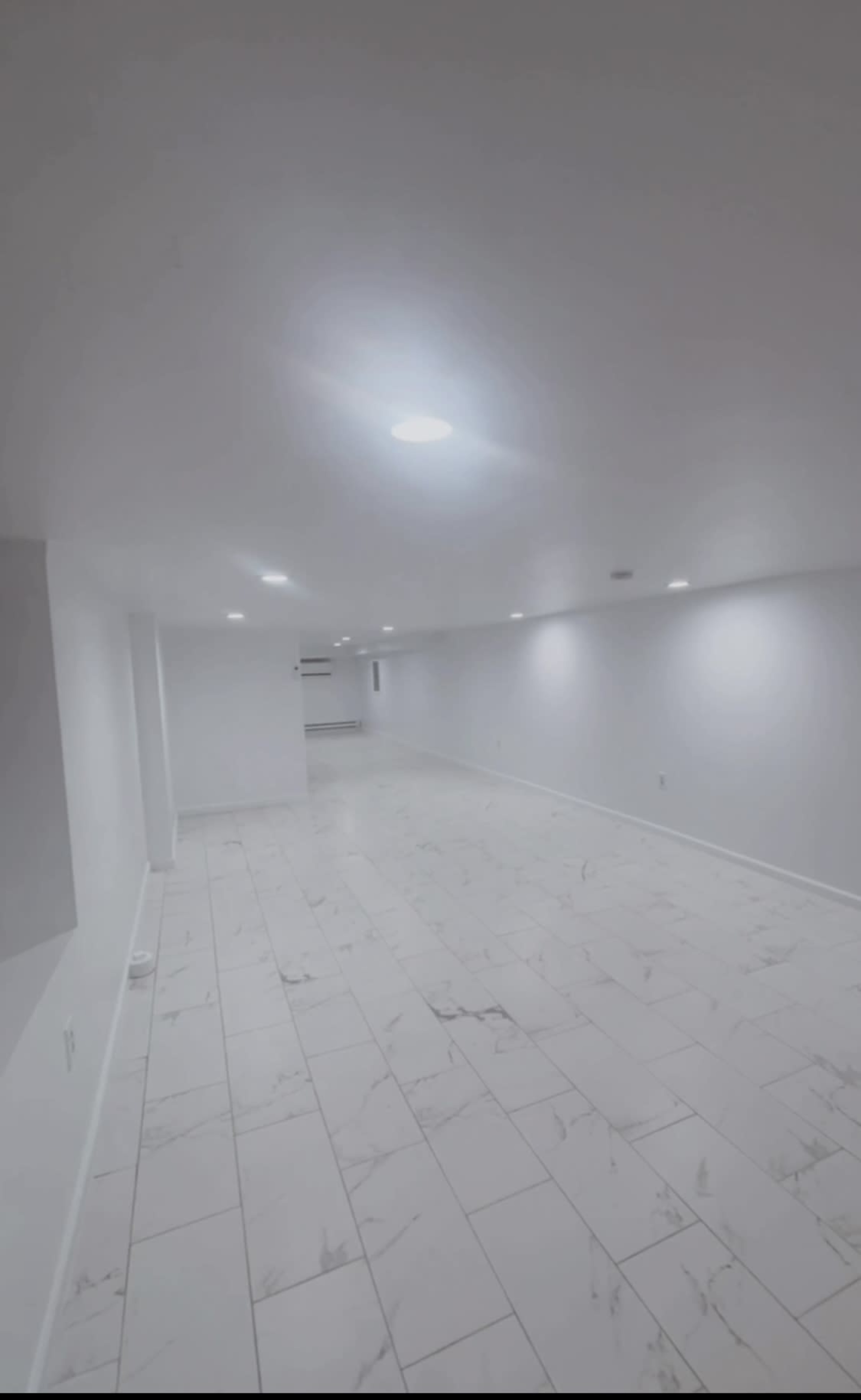 A modern elegant Event Space with white walls, gleaming white marble floors, and stunning customizable lighting, perfect for any occasion. Image in Kingsessing, Philadelphia, PA