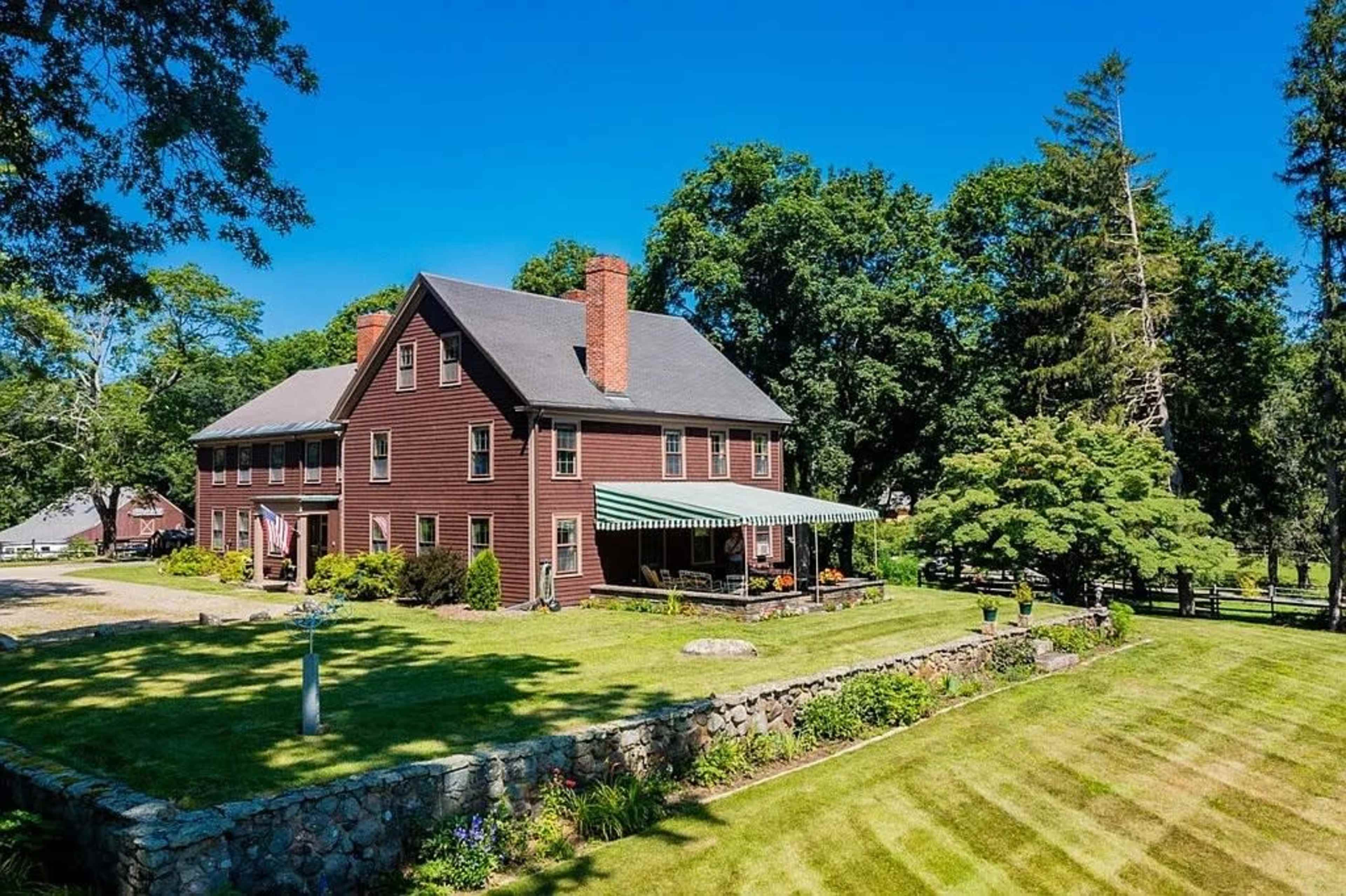 Tranquil antique farmhouse with horses grazing in the pastures. Image in Ipswich, Ipswich, MA