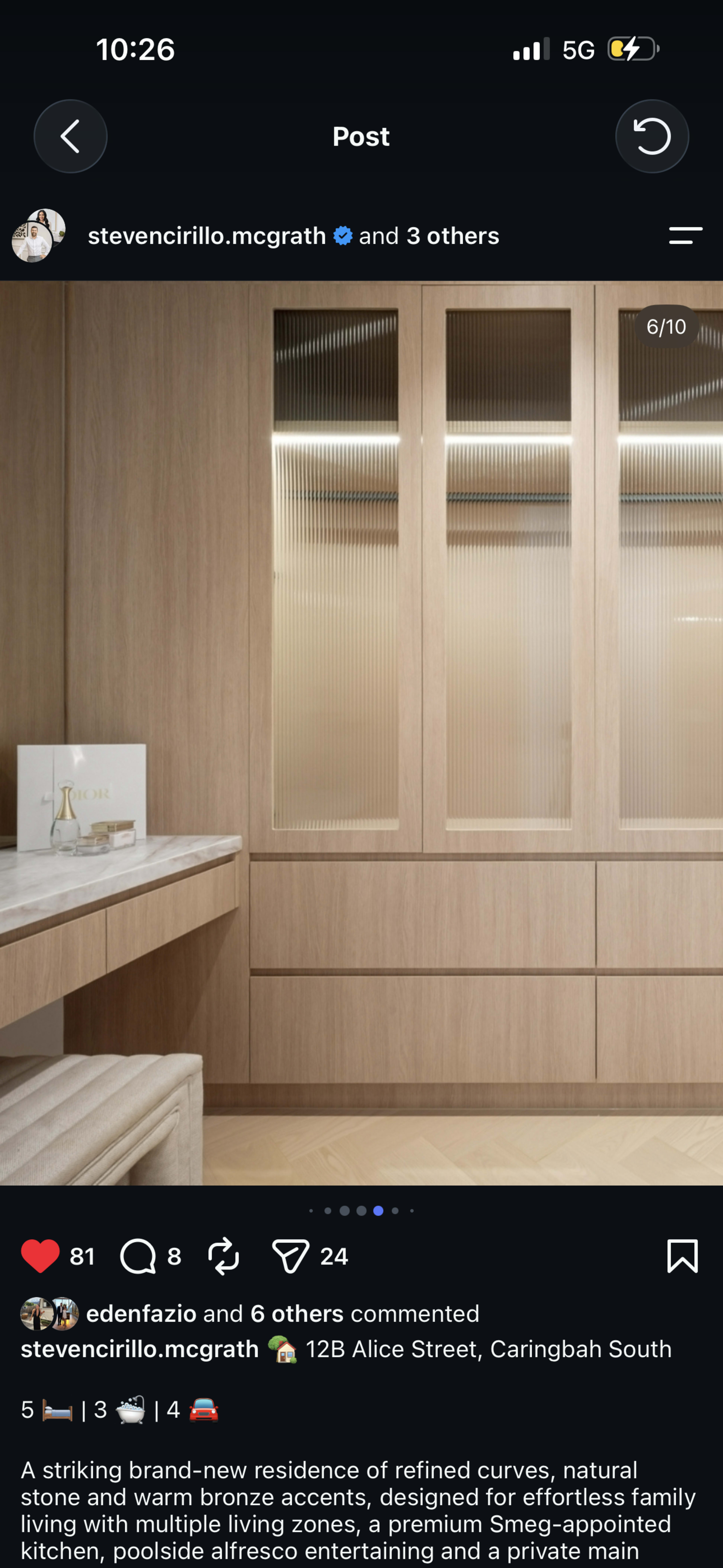 A modern interior space features wooden cabinetry with vertical lines, a light-colored counter, and a minimalist decorative element on the surface.