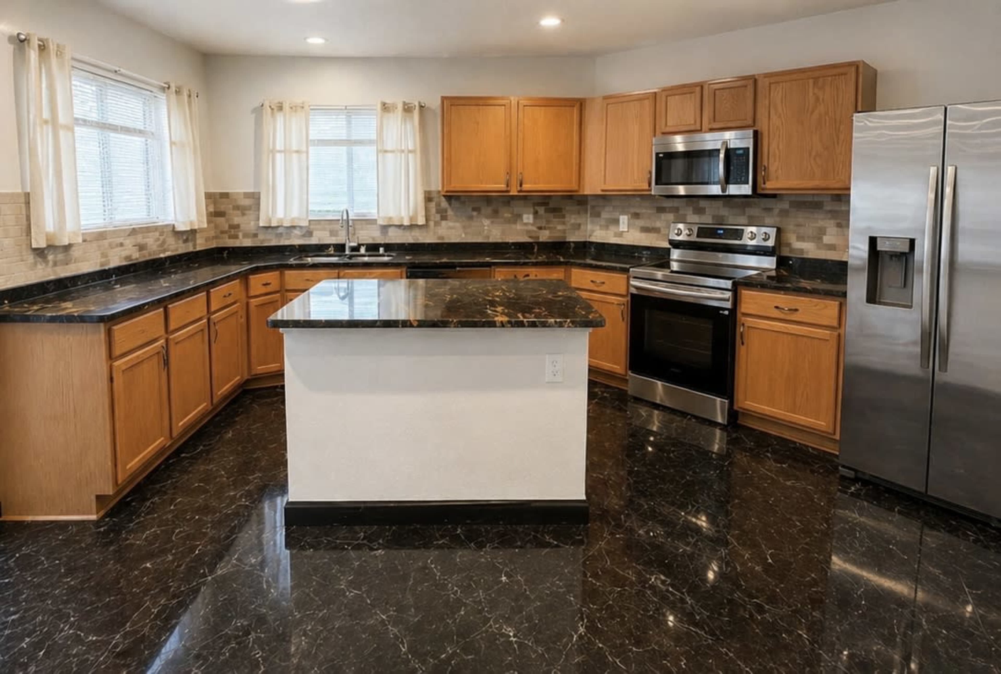 The image shows a modern kitchen featuring wooden cabinetry, stainless steel appliances, and dark marble countertops.