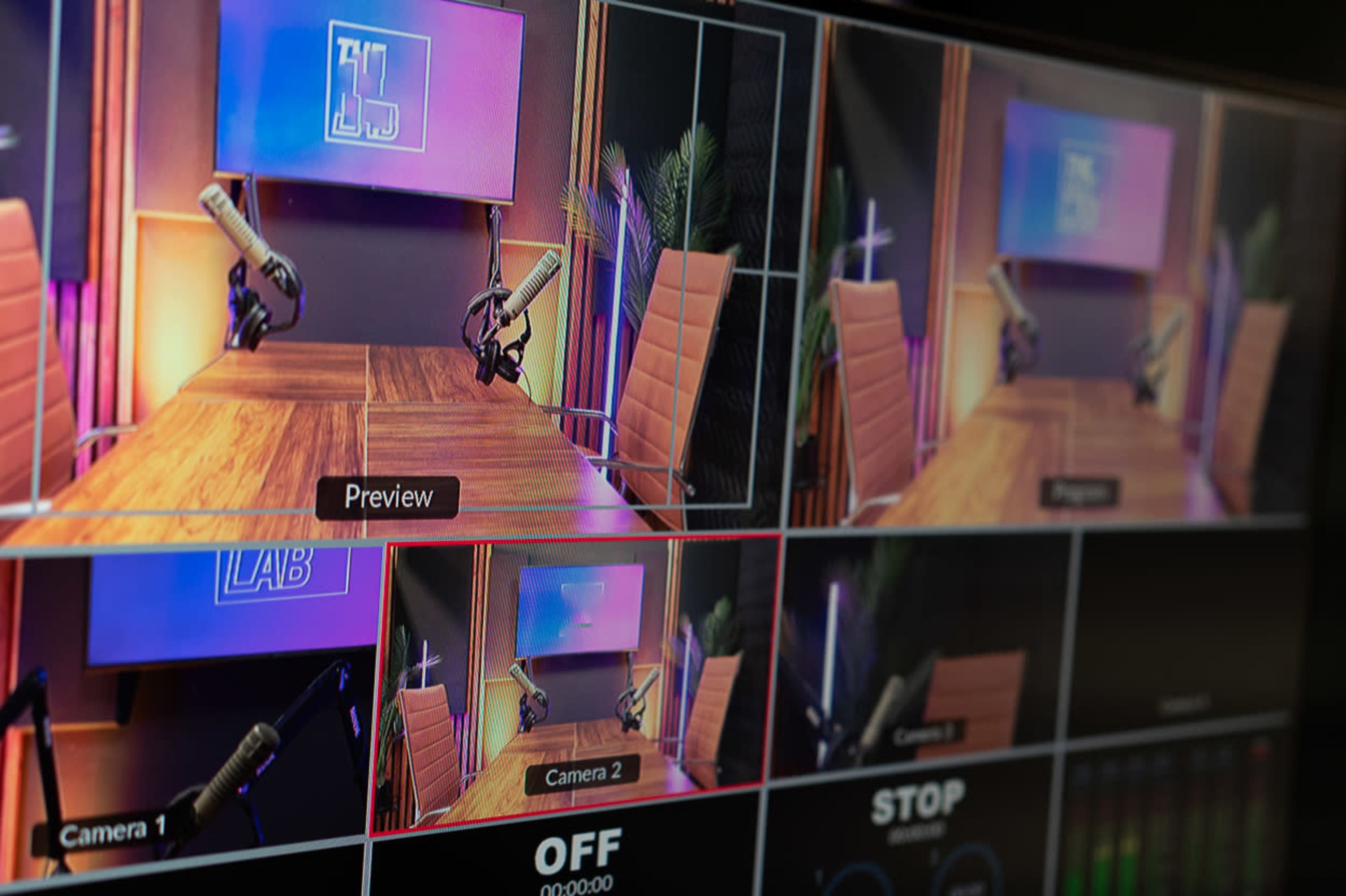A series of video feeds from a production studio, featuring a set with microphones and a brightly lit background.
