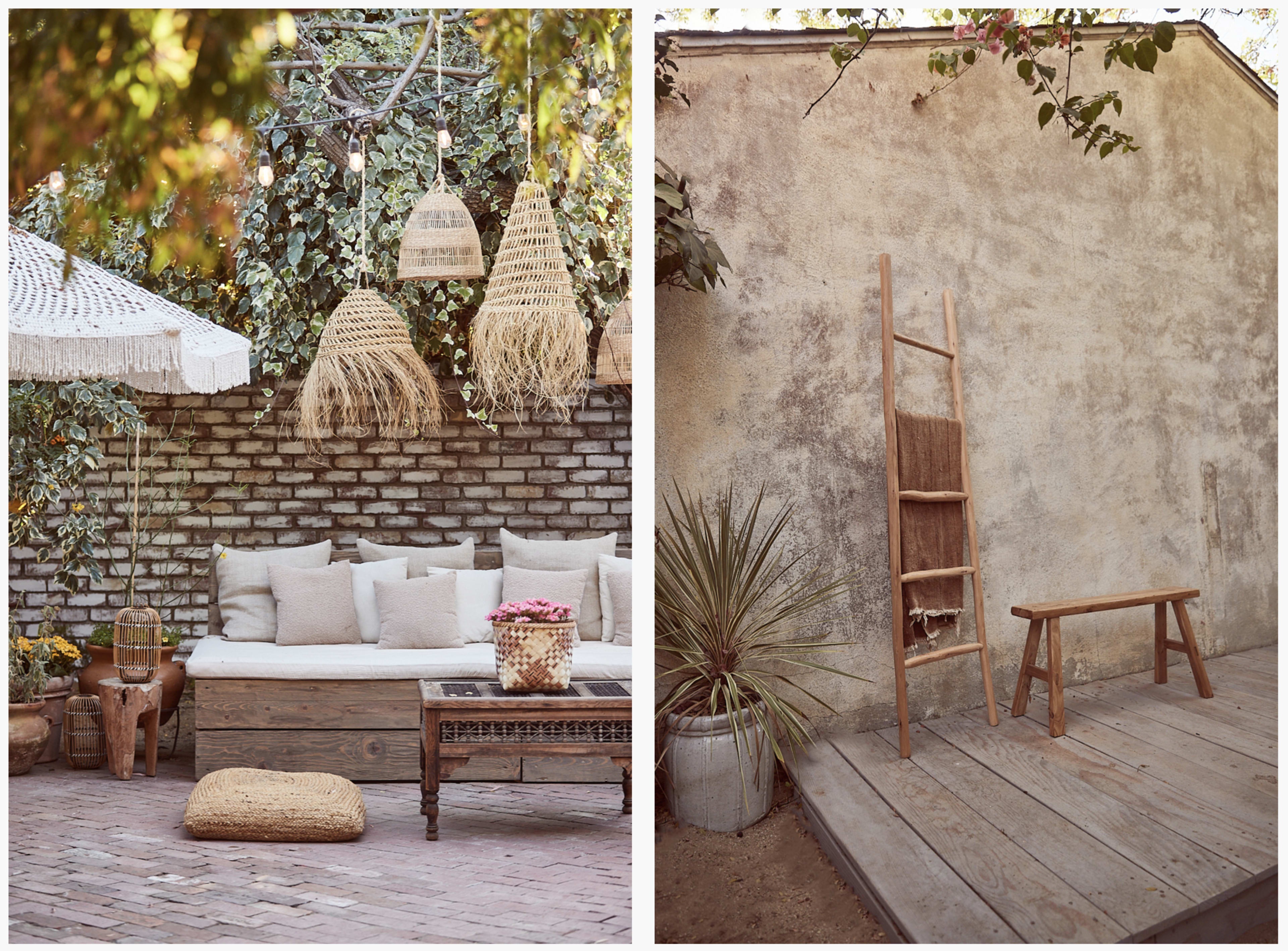 A cozy outdoor seating area with a cushioned bench, woven decor, and a wooden ladder against a textured wall, surrounded by plants.