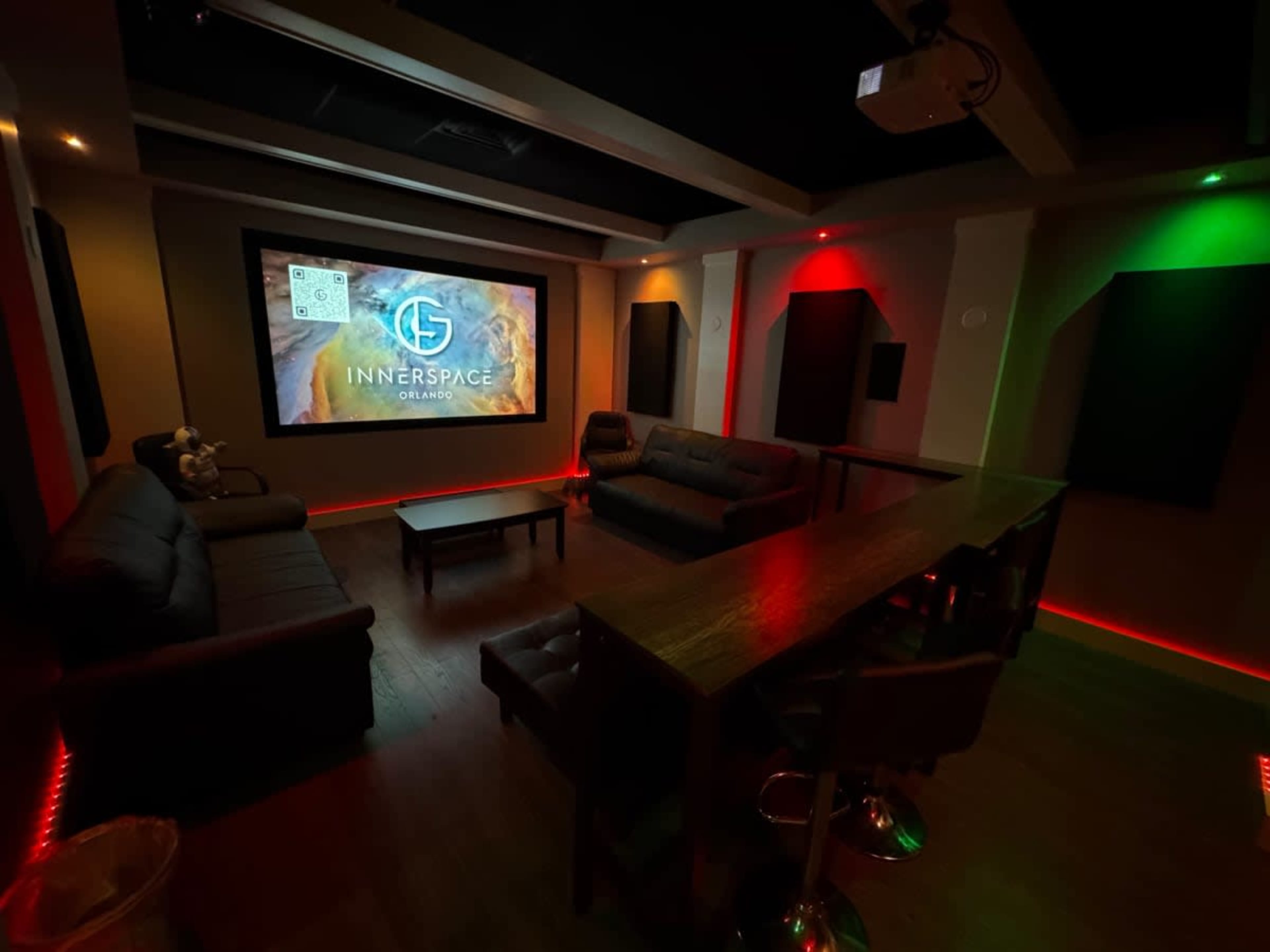 A cozy home theater room features a large screen at the front, comfortable seating, and adjustable lighting.