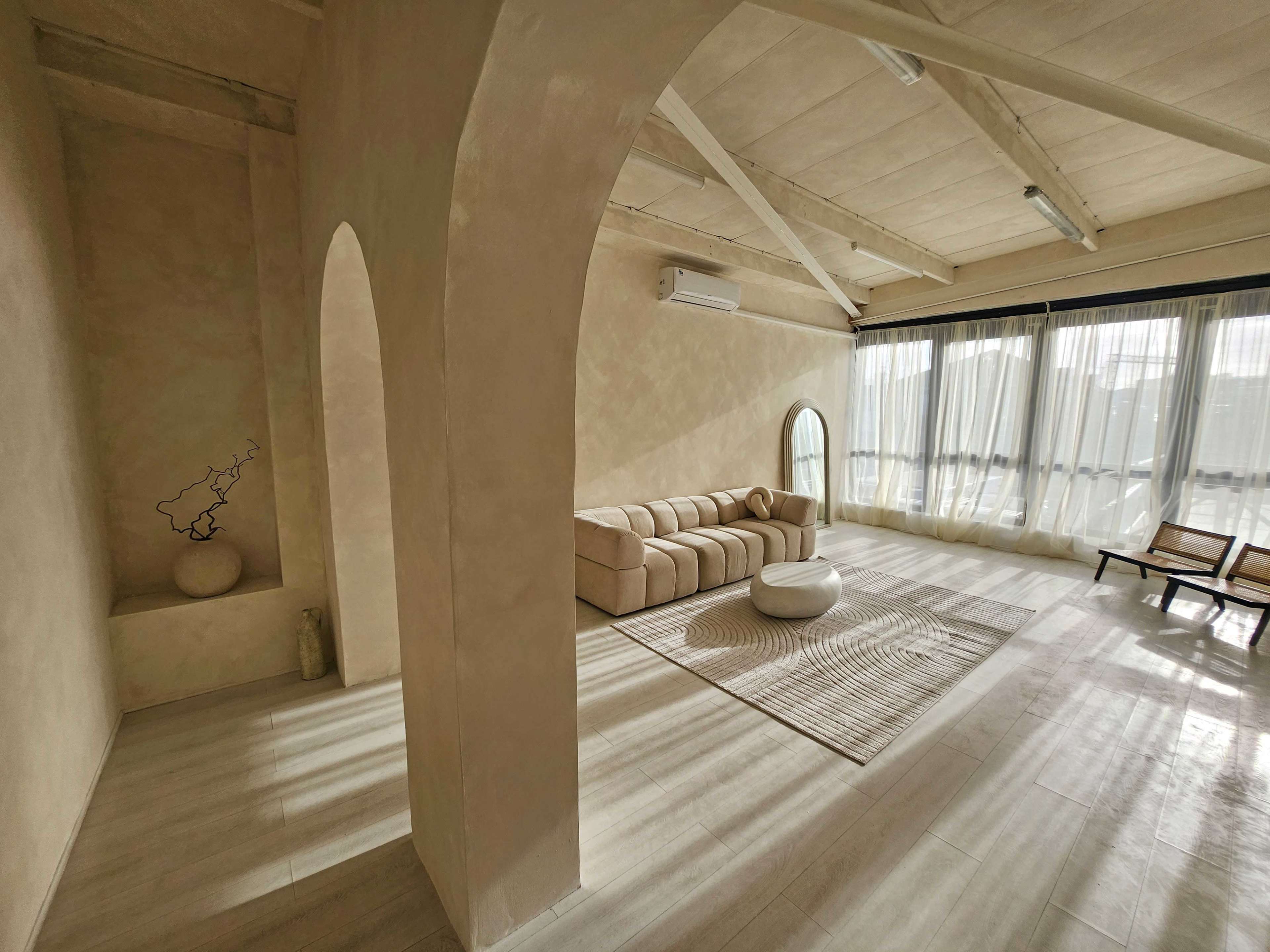 Sun-Kissed Lifestyle Studio with Elegant Arches & Textured Walls Image in London, Canning Town, ENG