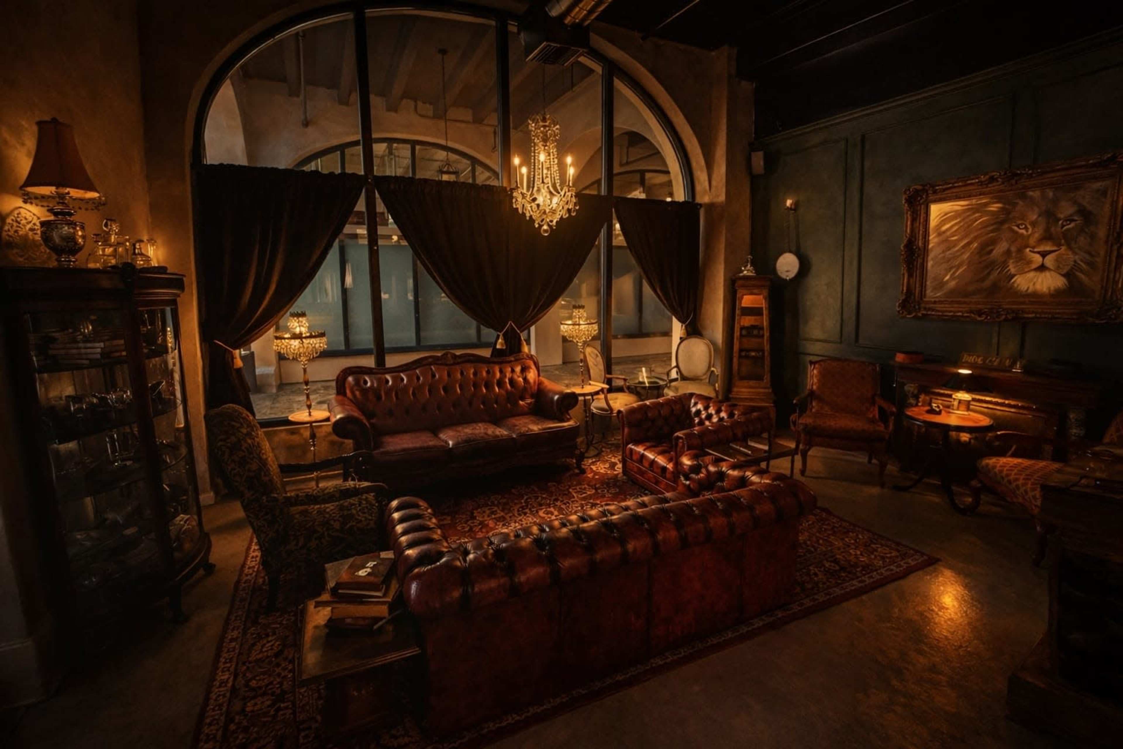 The image depicts a warmly lit, elegantly furnished room featuring a leather sofa and armchairs, a large window with drapes, and decorative elements like a chandelier and a lion painting.