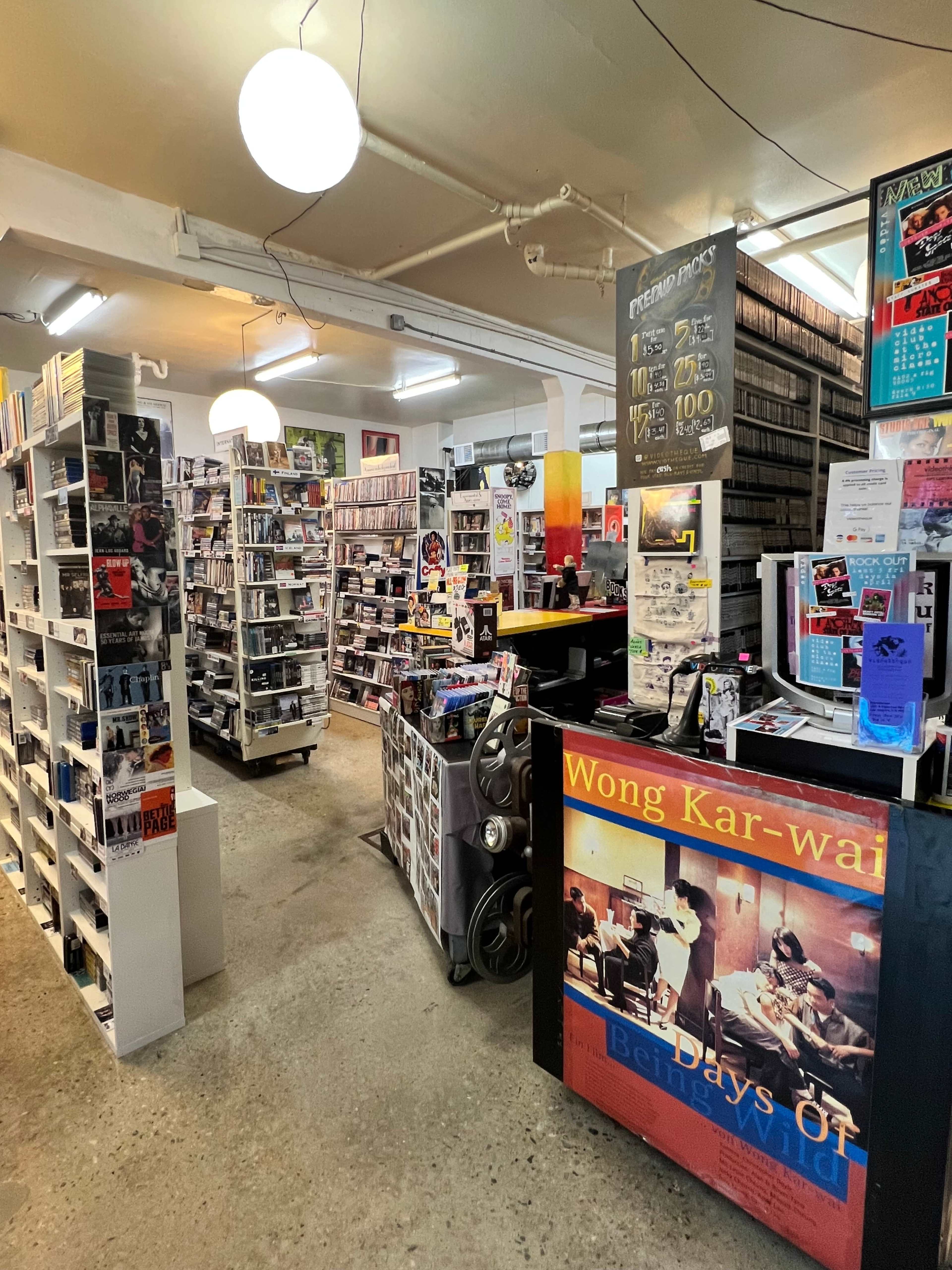 The interior of a music and movie store filled with shelves of CDs, DVDs, and posters.