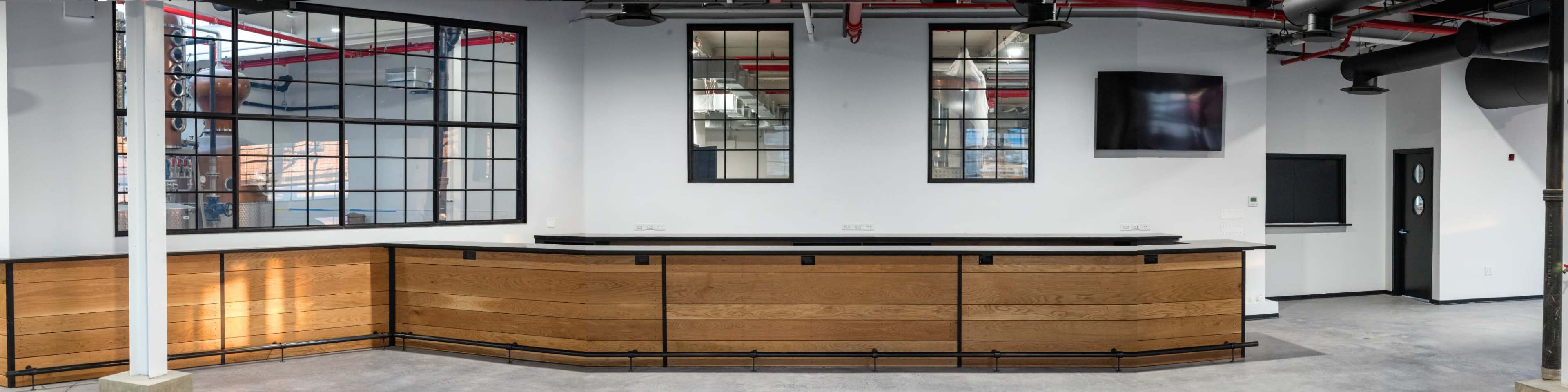 A modern reception area with a wooden front desk, large windows, and a minimalist design.