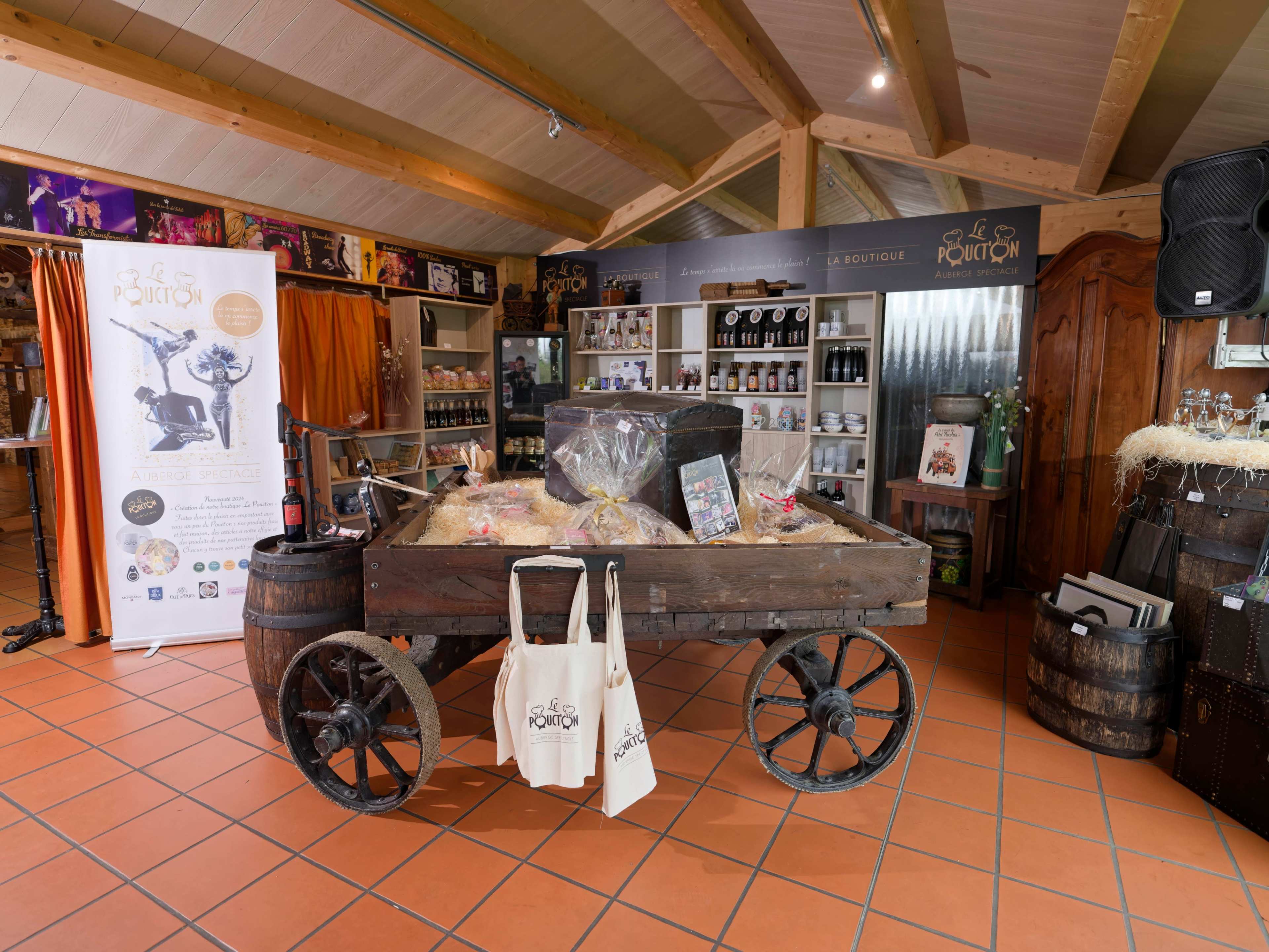A wooden cart filled with products sits in a shop displaying various food items, surrounded by shelves and promotional materials.