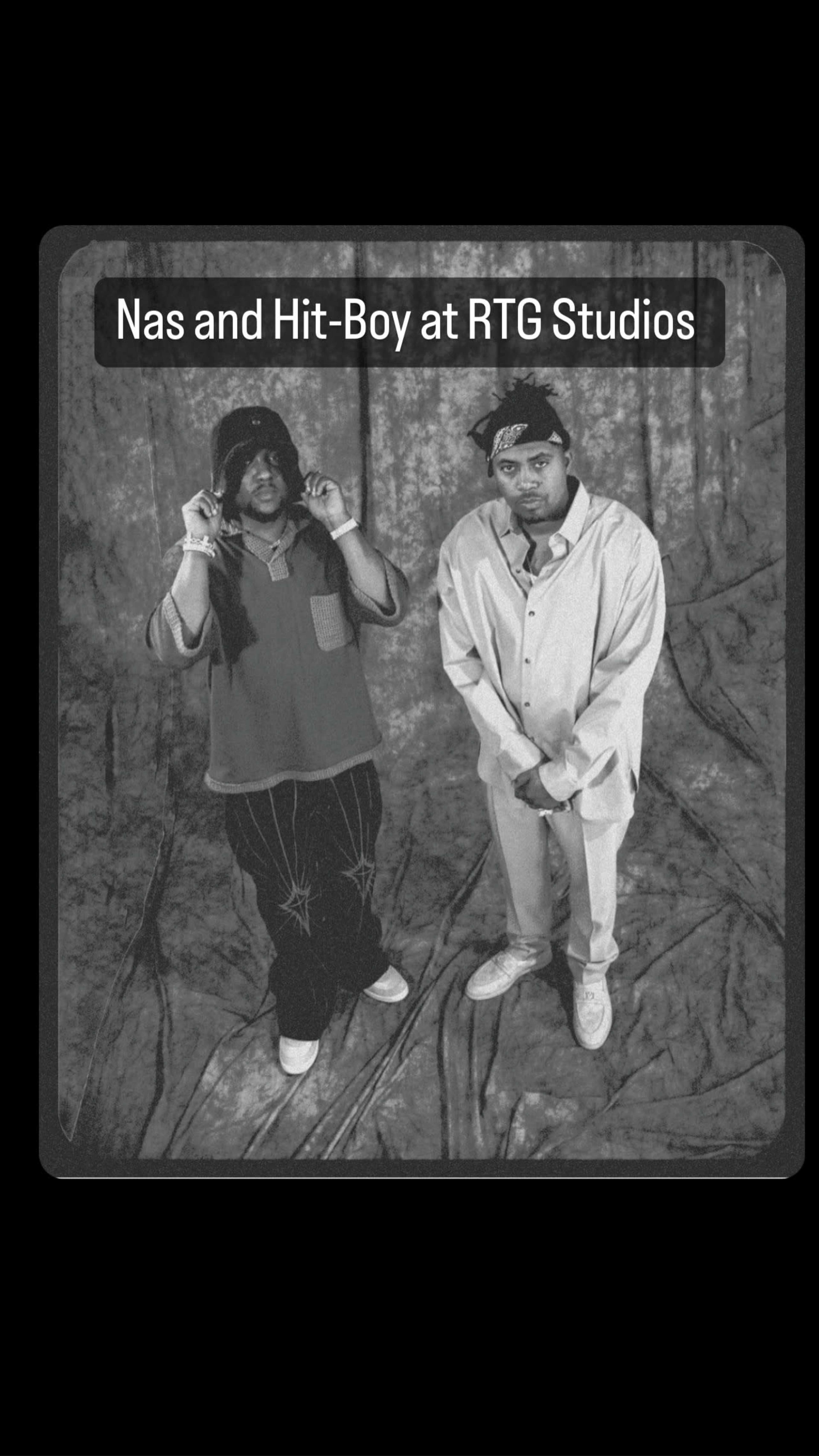 The image shows two men, Nas and Hit-Boy, posing in front of a draped backdrop at RTG Studios.