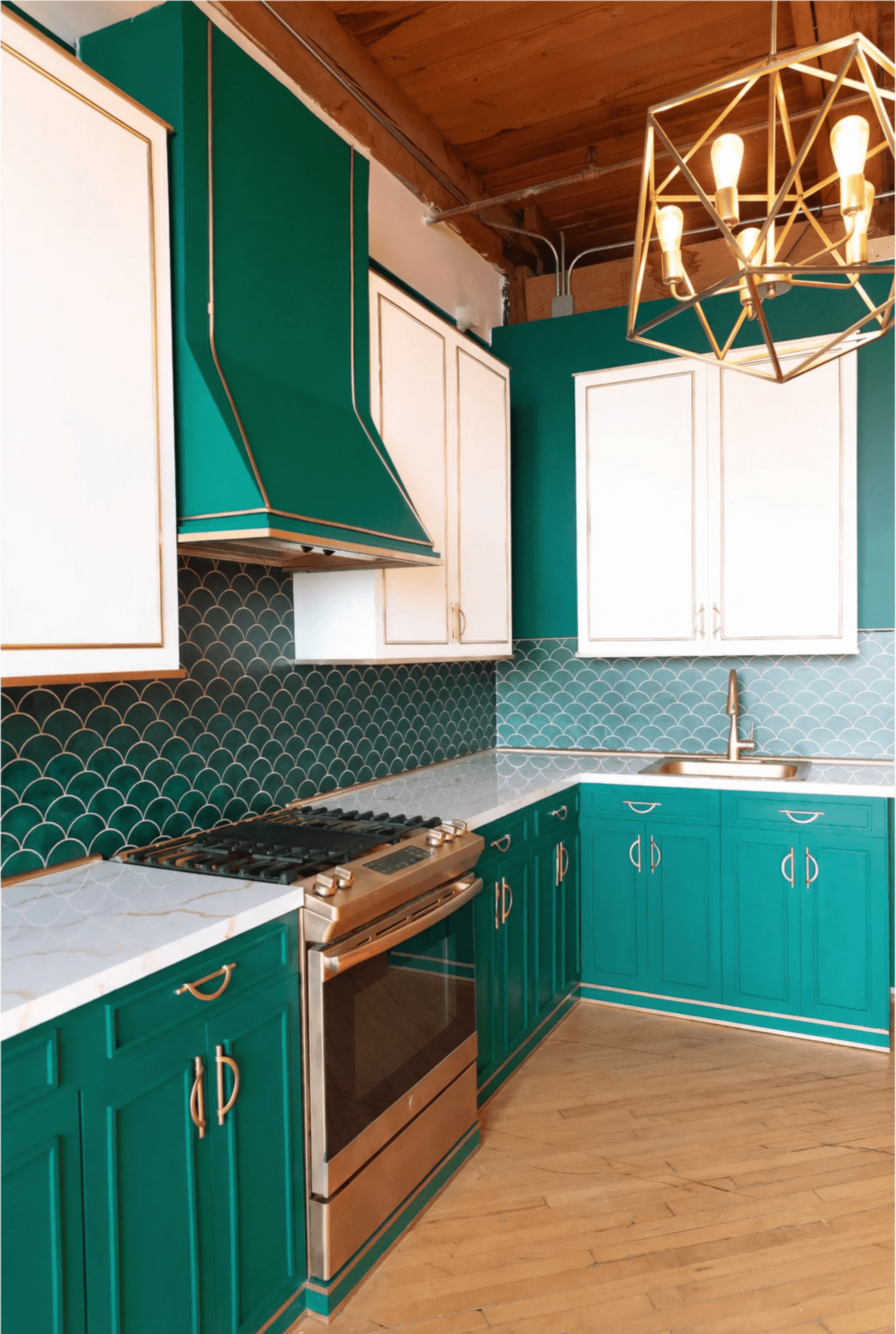 The kitchen features teal cabinetry, a marble countertop, and a decorative tile backsplash arranged in a fish-scale pattern.