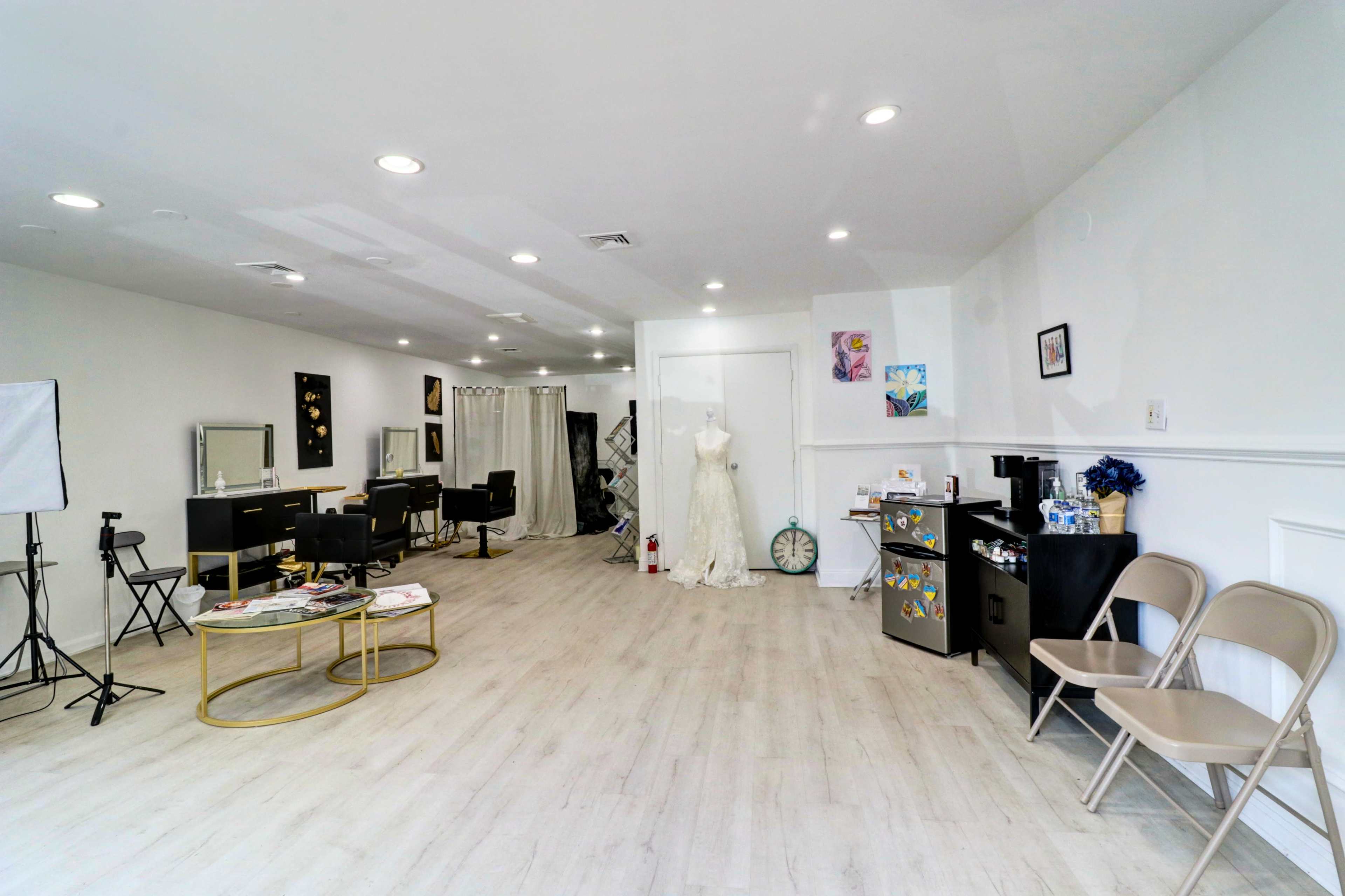 The image shows a spacious and well-lit salon area with hair styling stations, chairs, and a dress form displaying a wedding gown.