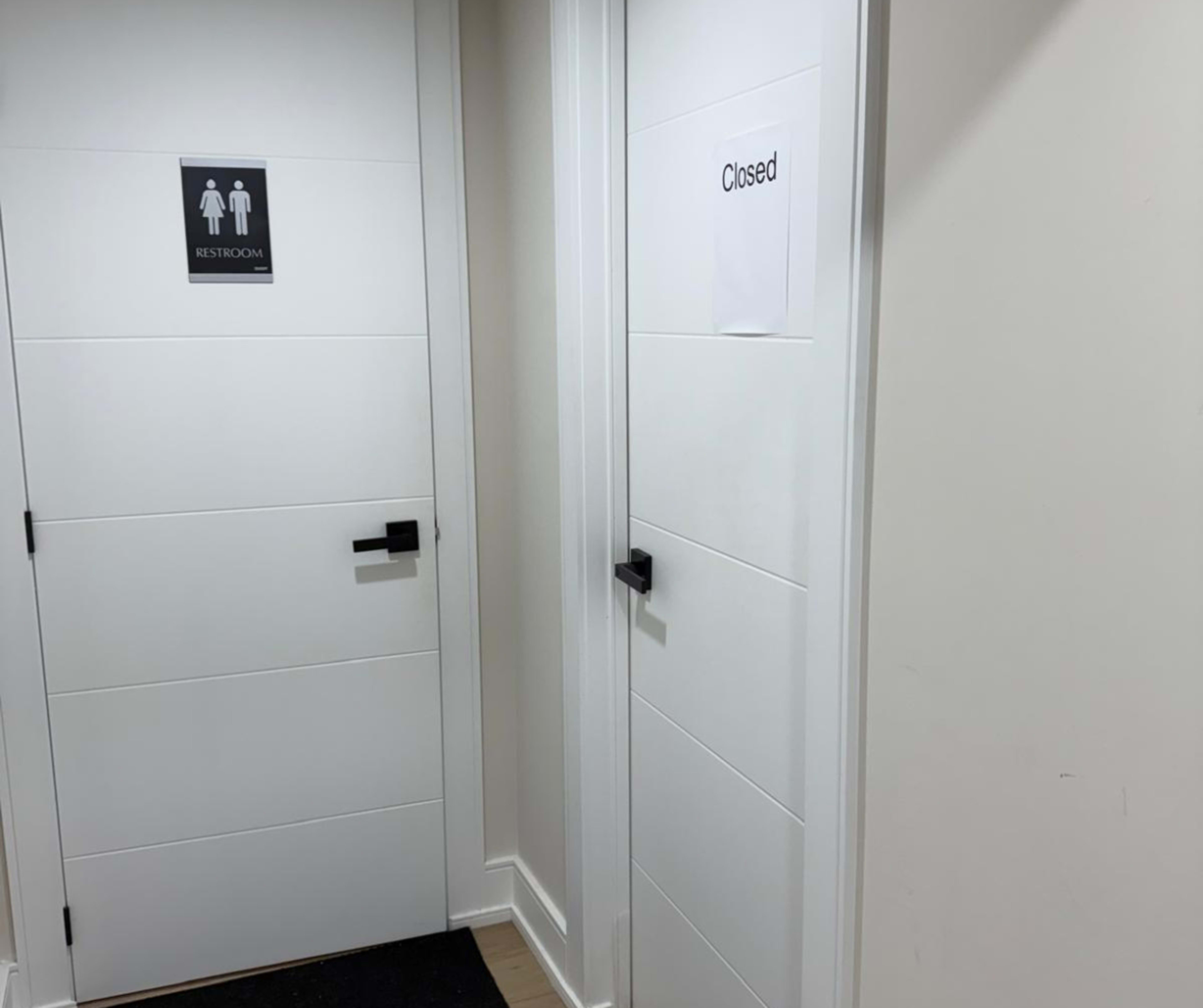 The image shows two restroom doors: one labeled "RESTROOM" and the other marked "Closed."