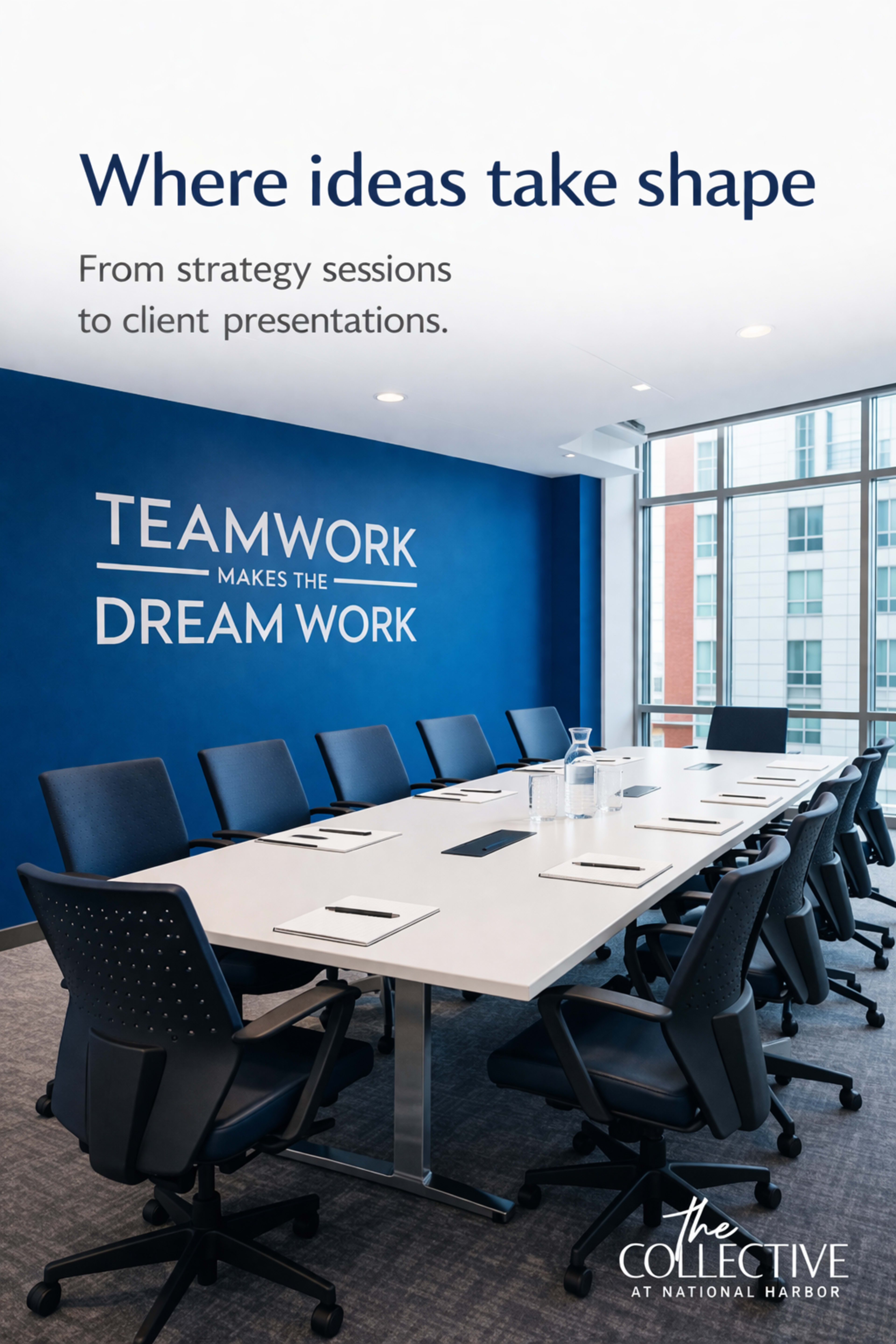 The image shows a modern conference room with a long white table and multiple black office chairs arranged around it, featuring a blue wall with motivational text.