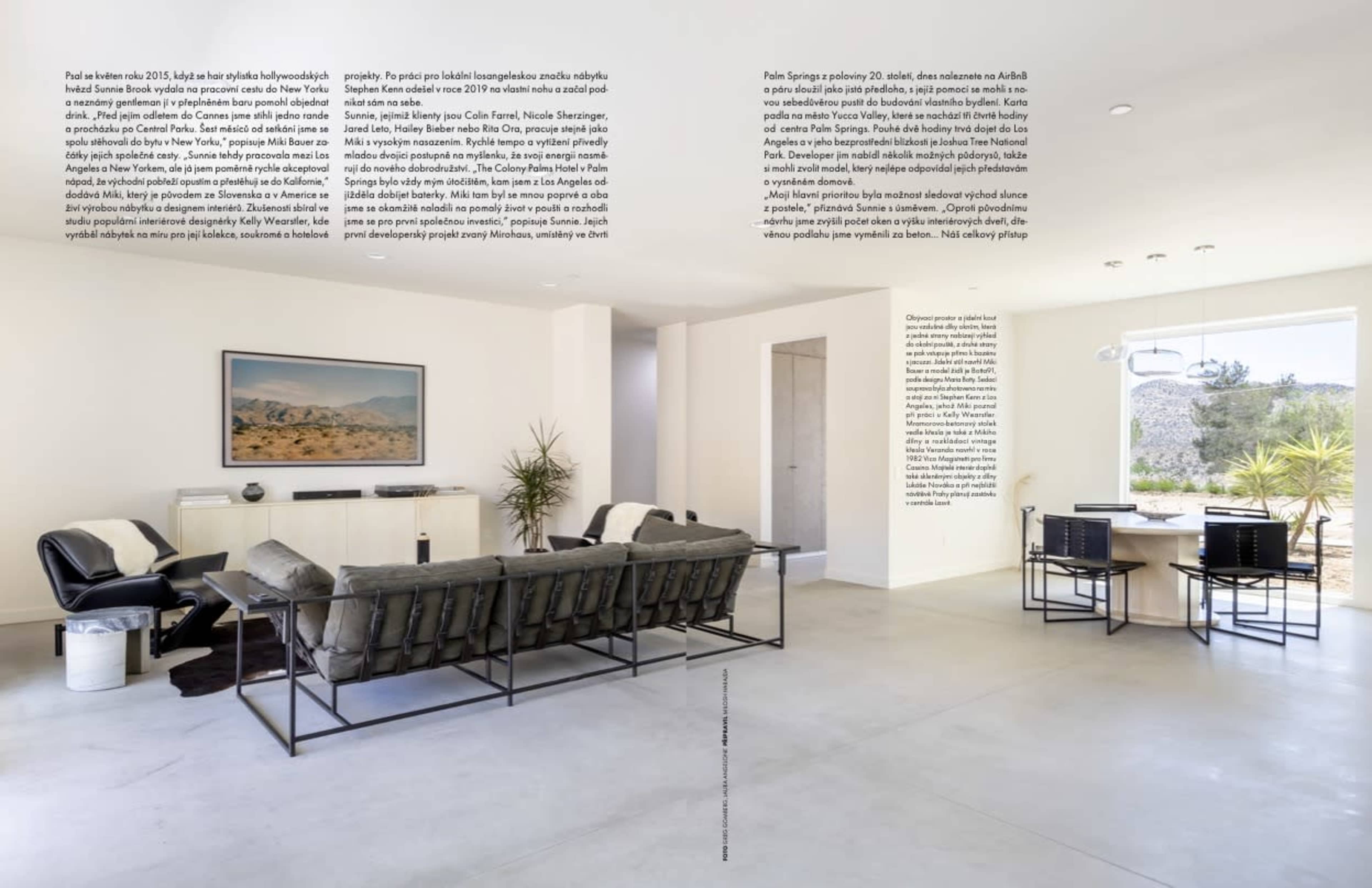 The image shows a modern, open-concept living area with a sleek black sofa set, a dining table, and large windows allowing natural light to fill the space.