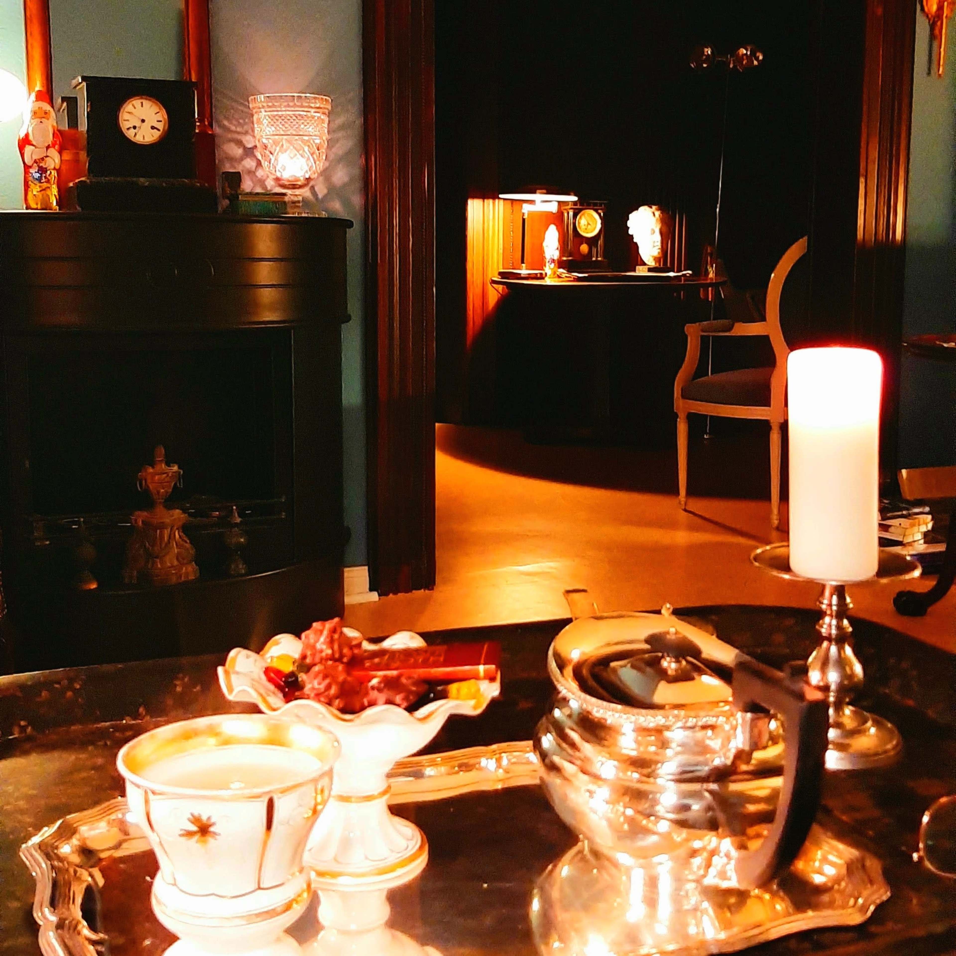 The scene features a vintage-style living room with a decorative table set in the foreground, a lit candle, and a glimpse of a dimly lit area in the background.
