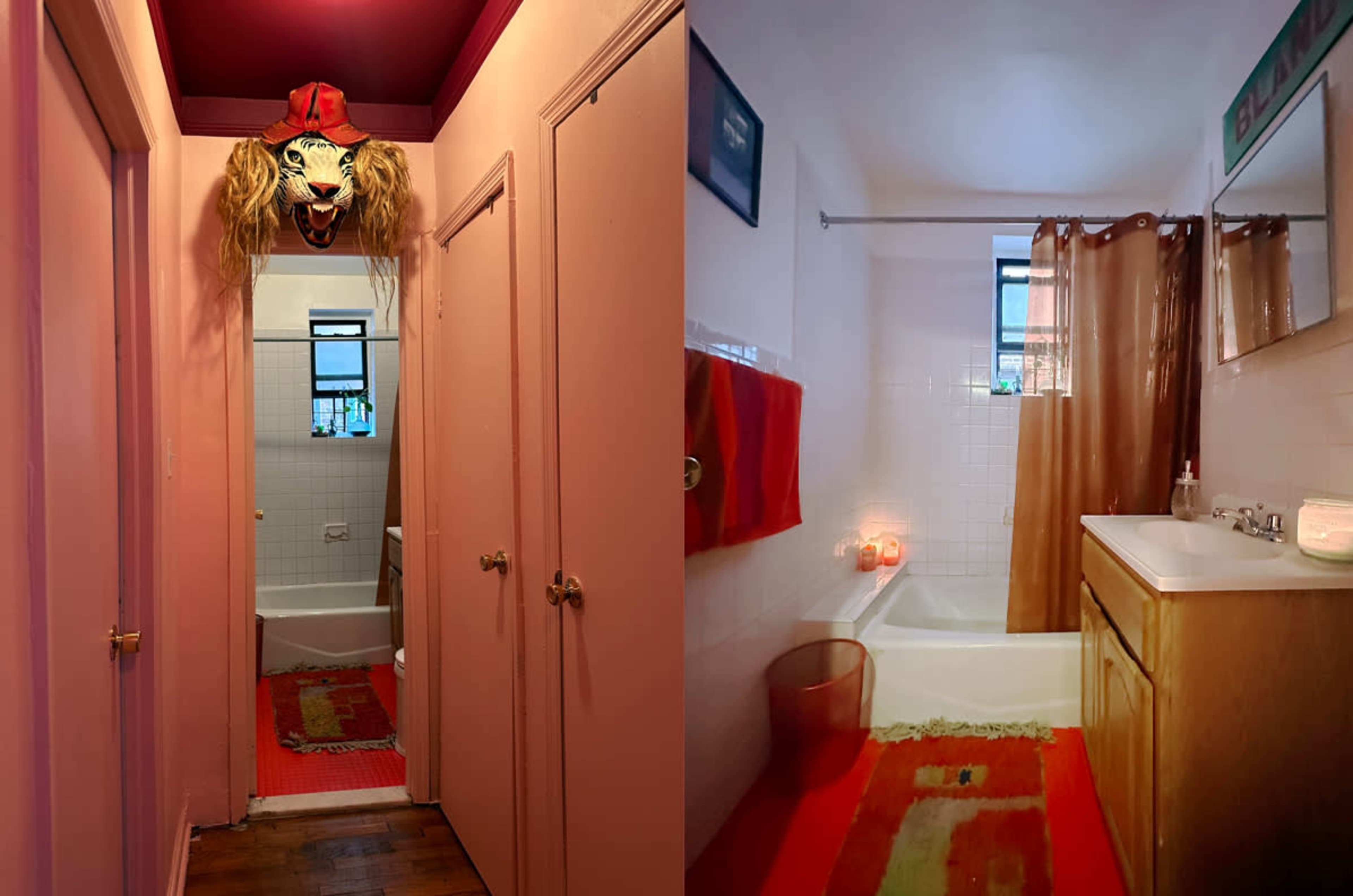 The image shows a pink hallway leading to a bathroom, featuring a lion mask on the wall, with the bathroom visible through the doorway and containing beige walls, a bathtub, and a sink with candles.