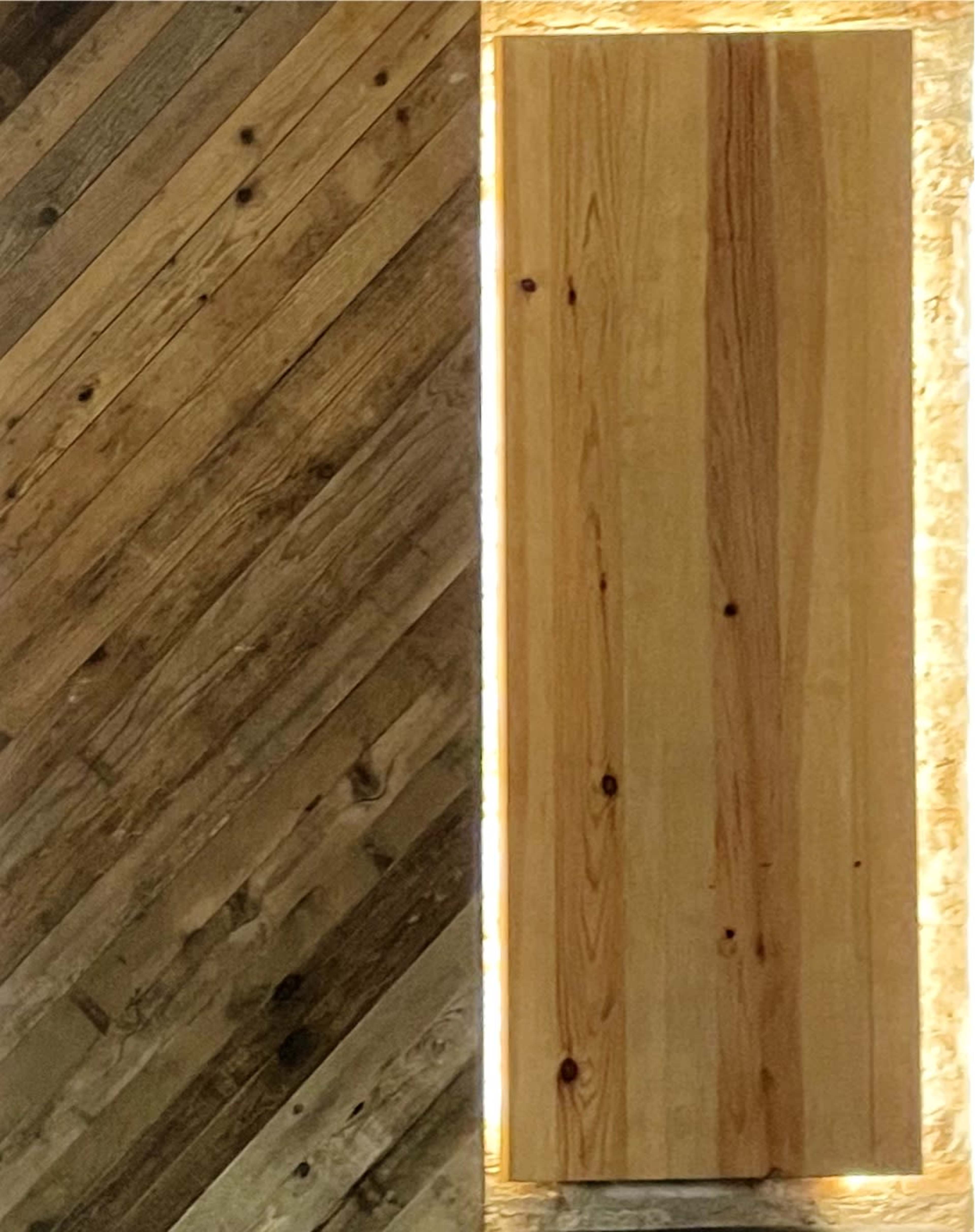 Two wooden panels, one with a diagonal pattern and a textured finish, and the other a smooth, vertically oriented door illuminated by light around its edges.