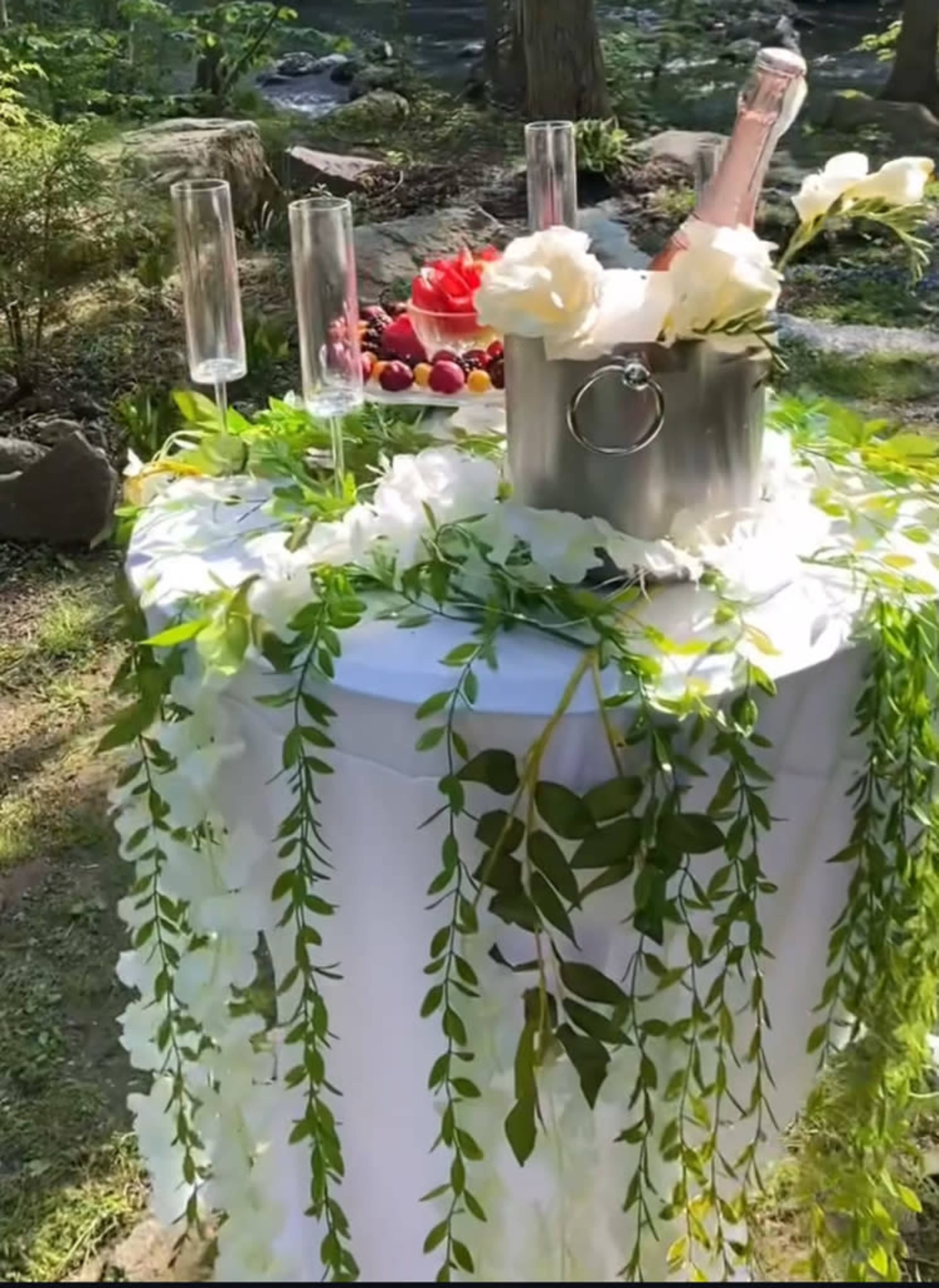 Champagne table setting in the garden with flutes 
