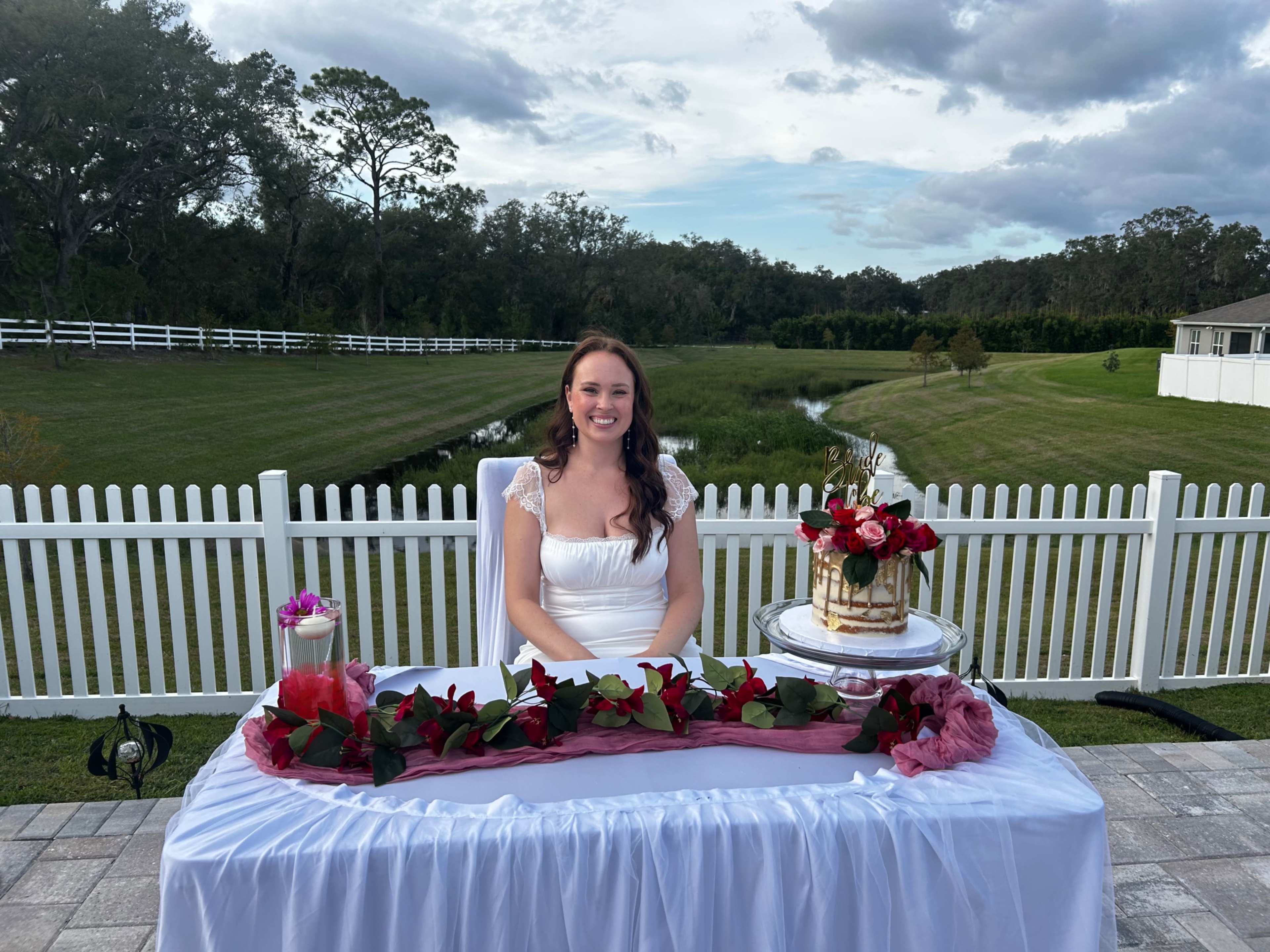 Charming Outdoor Photography Space with Greenery + White Picket Fence Backdrop Image in Leesburg, Okhumpka, FL