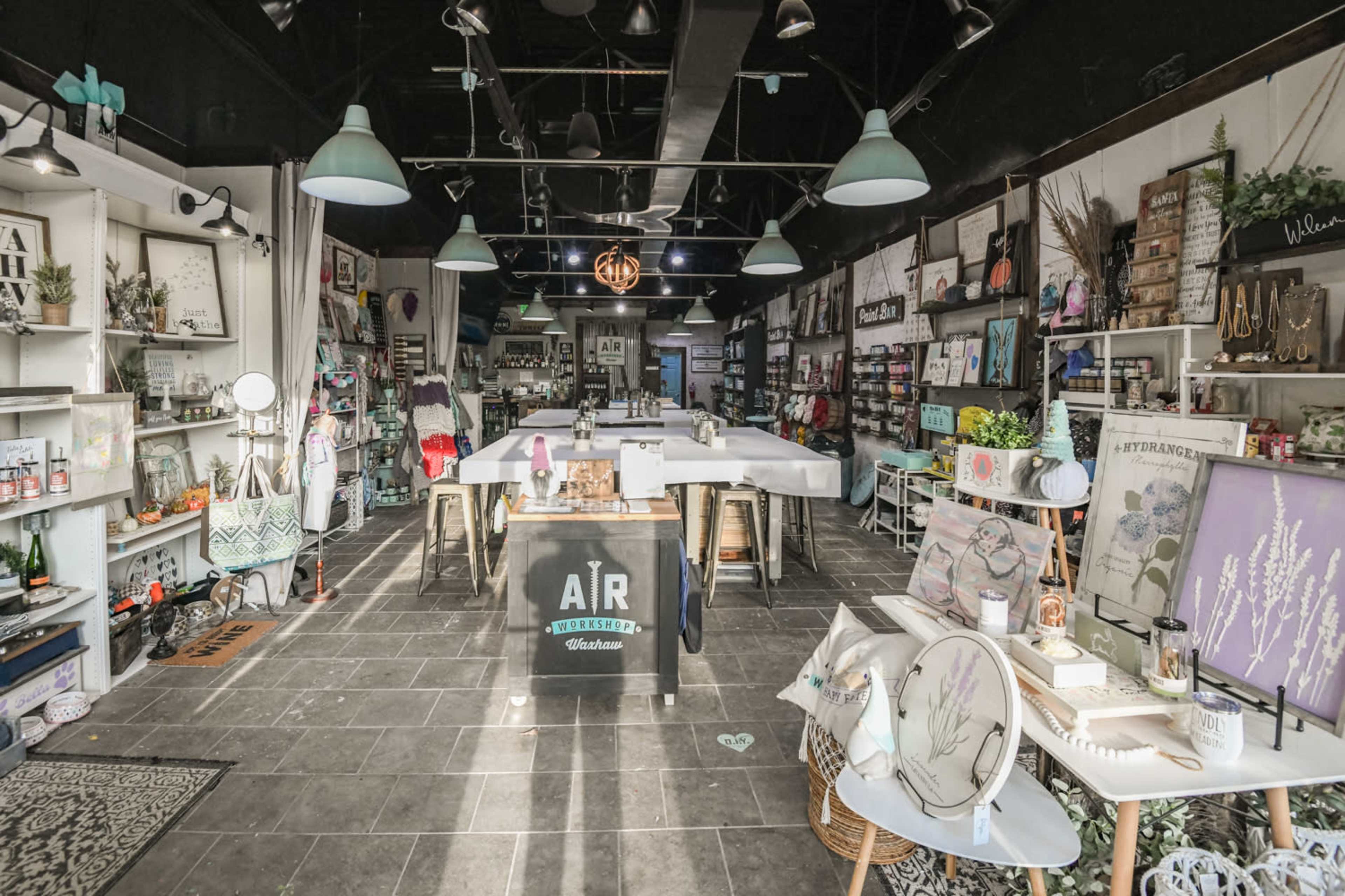 A craft and home goods store with various displayed items, including decor and supplies, arranged on shelves and tables.