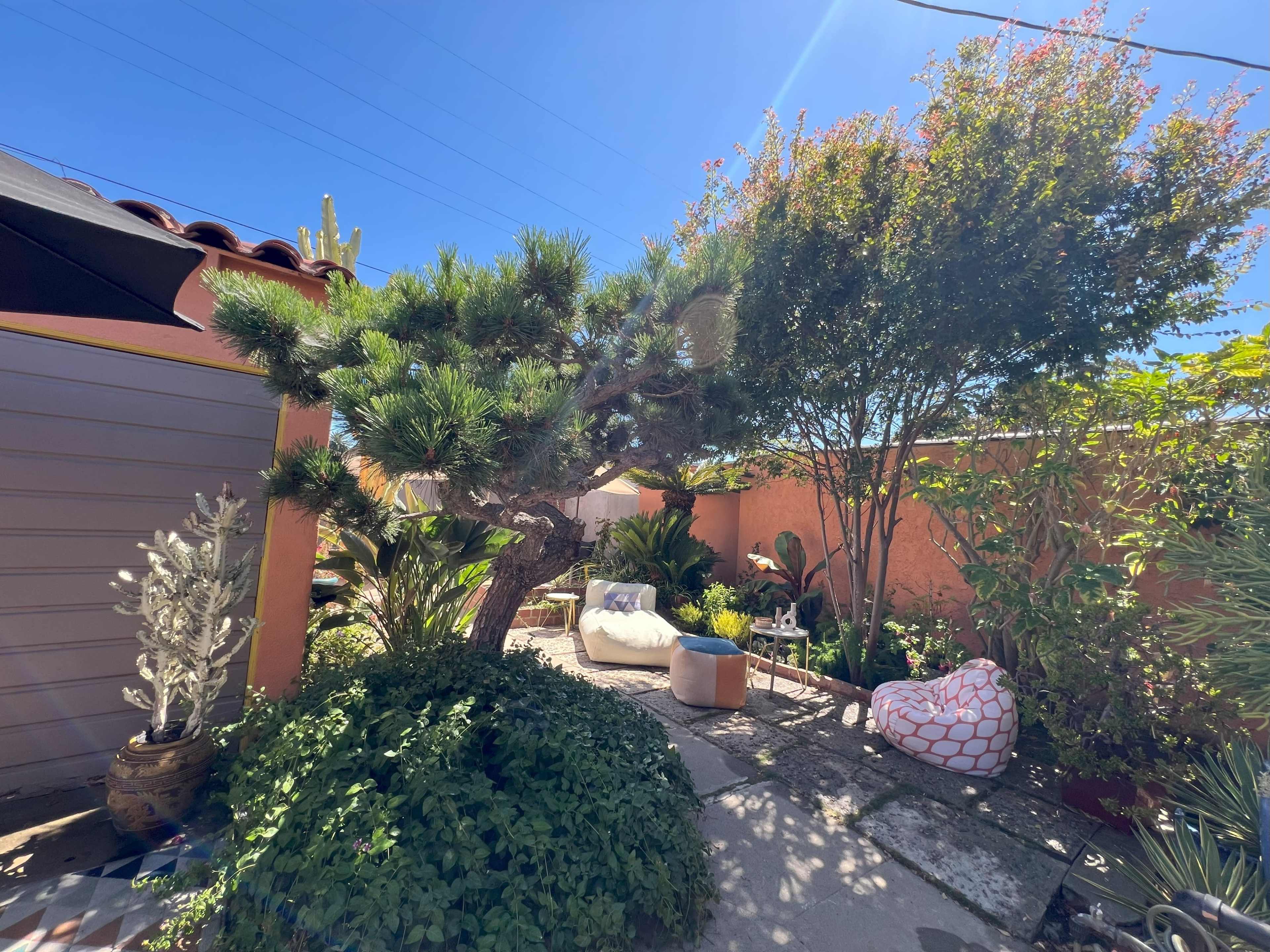 Charming Spanish-Style Backyard with Lush Garden & Private Nooks Image in Hyde Park, Los Angeles, CA