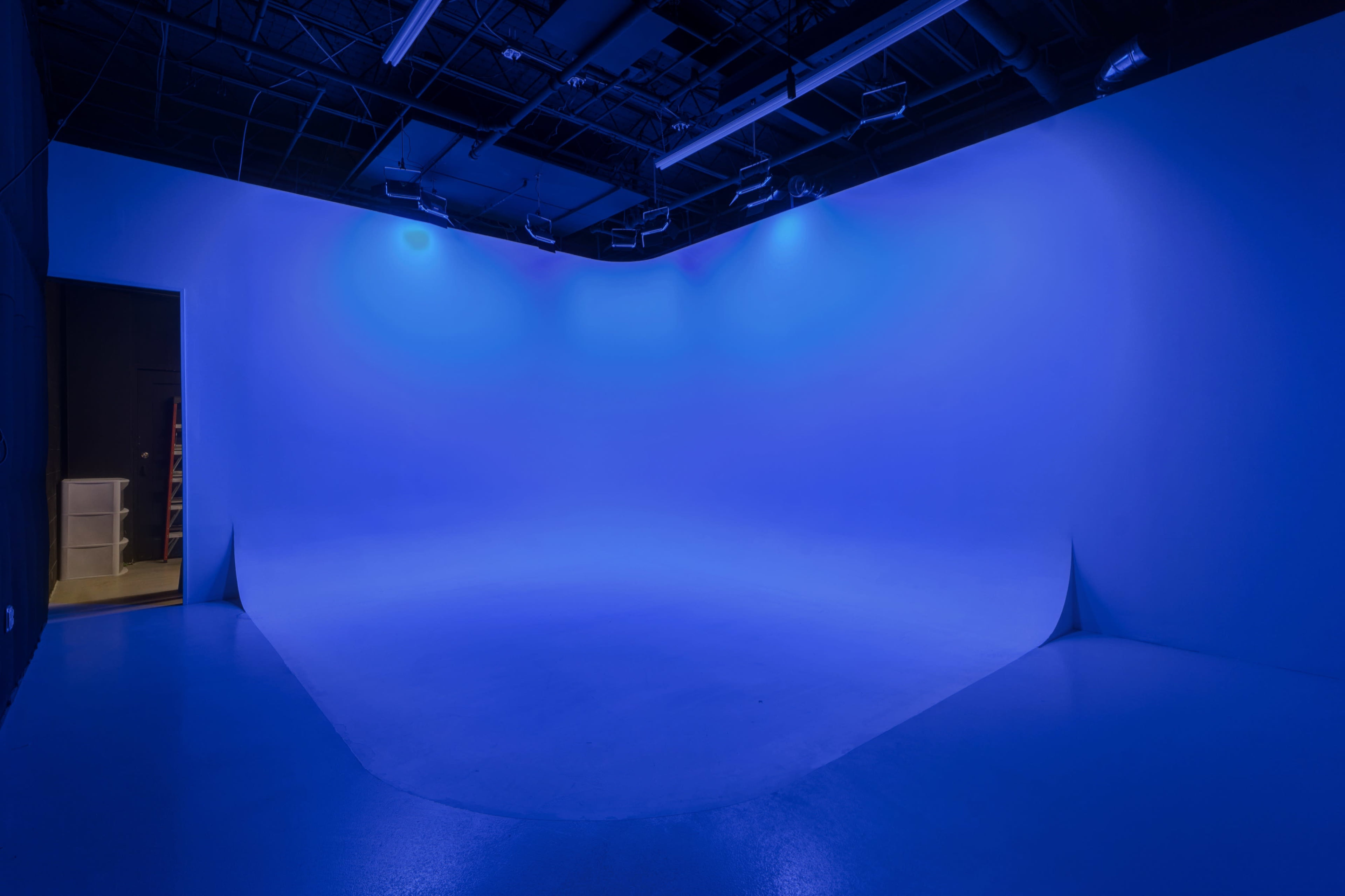 A studio space with a smooth blue backdrop and soft lighting.