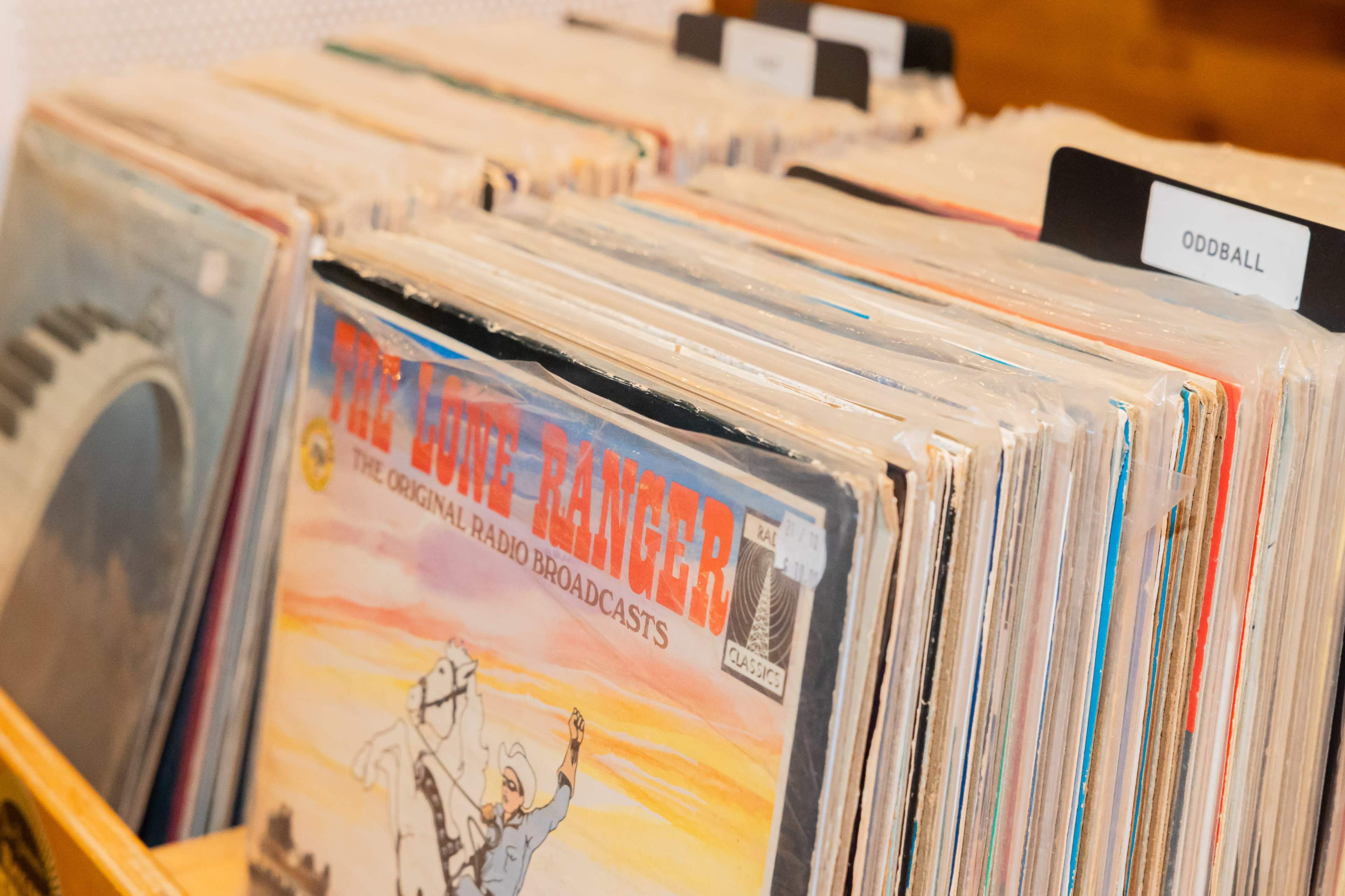 A collection of vinyl records is displayed in a box, with one record prominently titled "The Lone Ranger: The Original Radio Broadcasts."