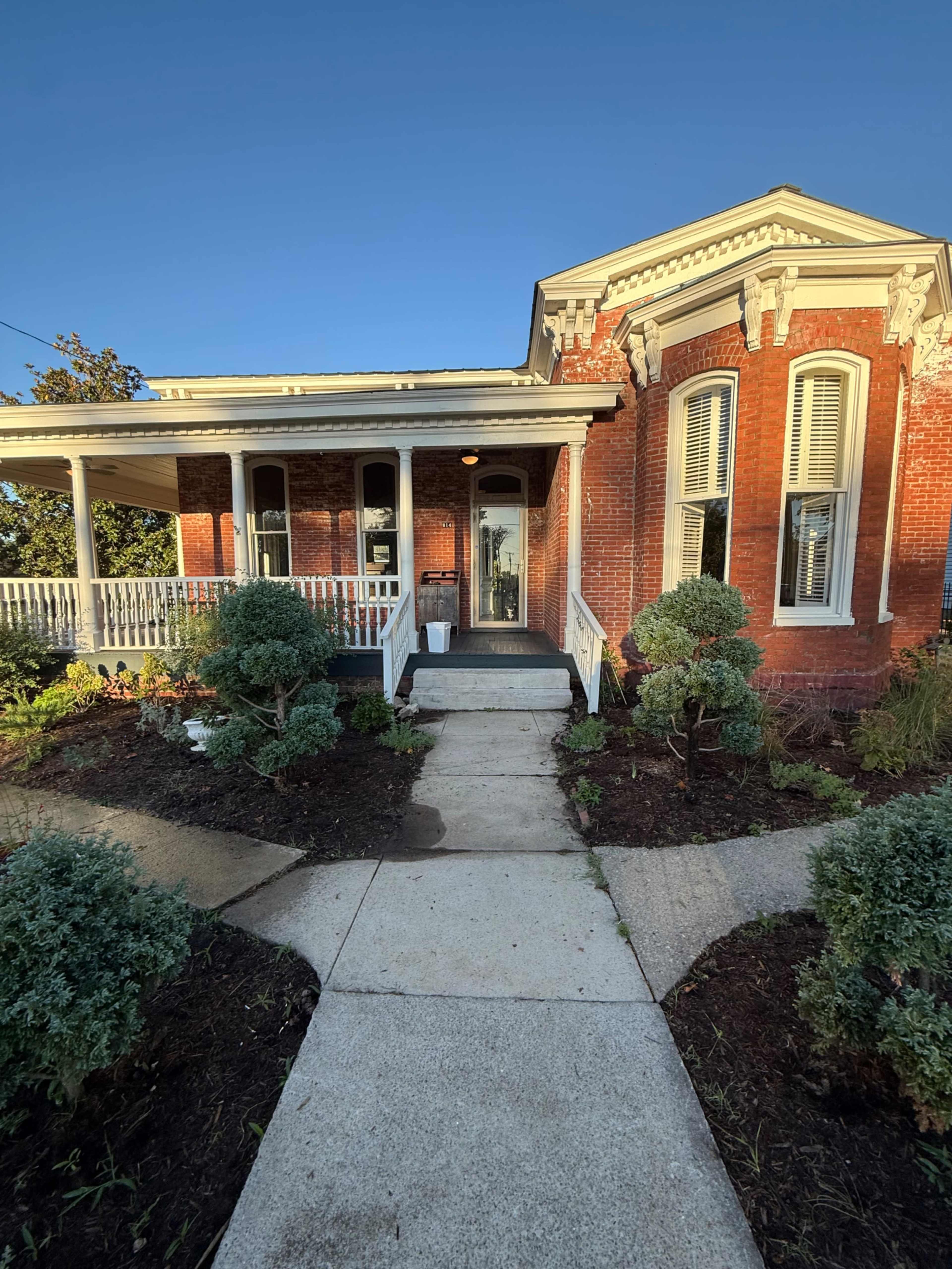 Brick Victorian with wrap around porch and exposed brick interior. Image in East Nashville, Nashville, TN