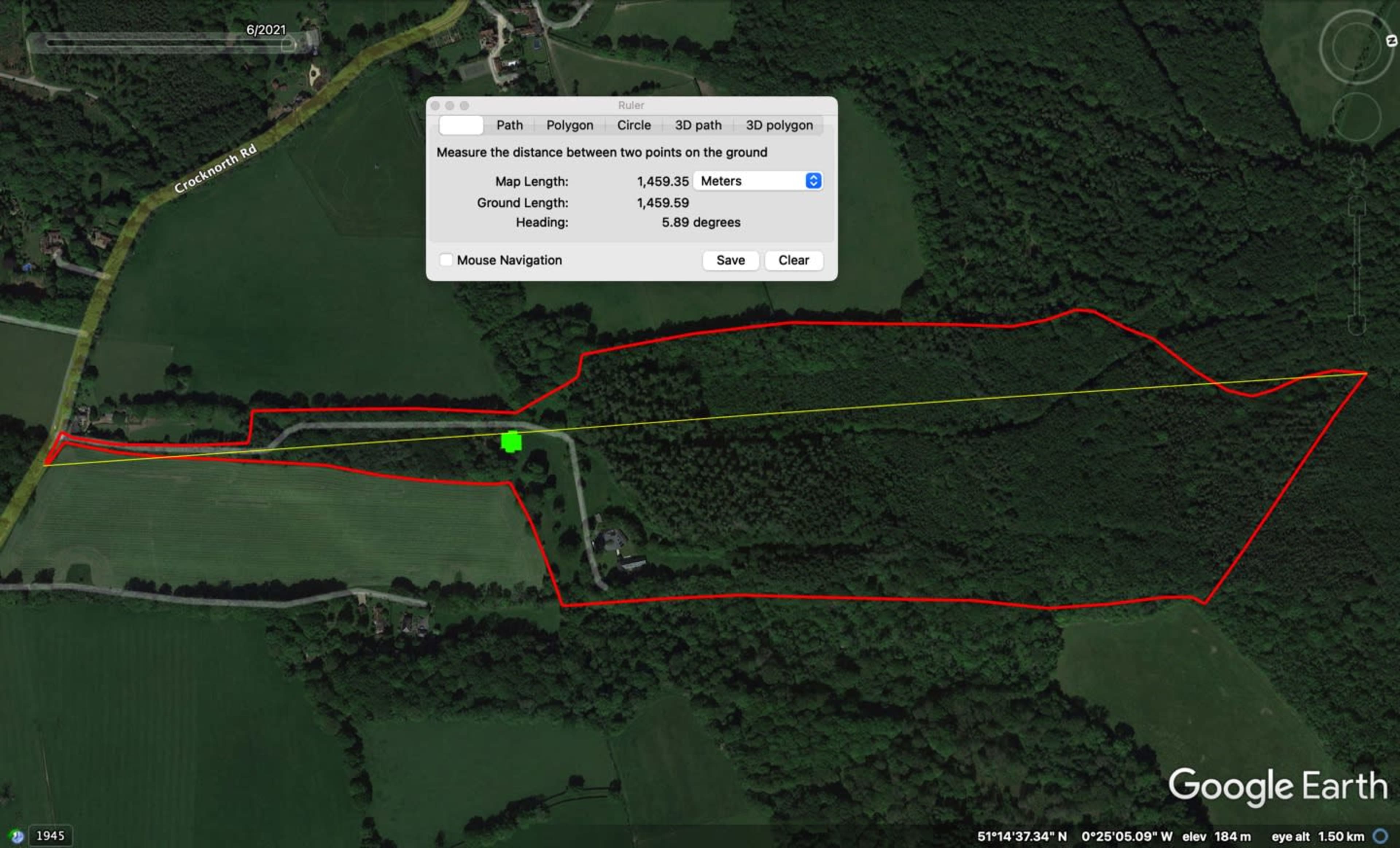 The image shows a satellite view of a wooded area with a mapped path outlined in red and yellow, indicating a route for measuring distance on the ground.