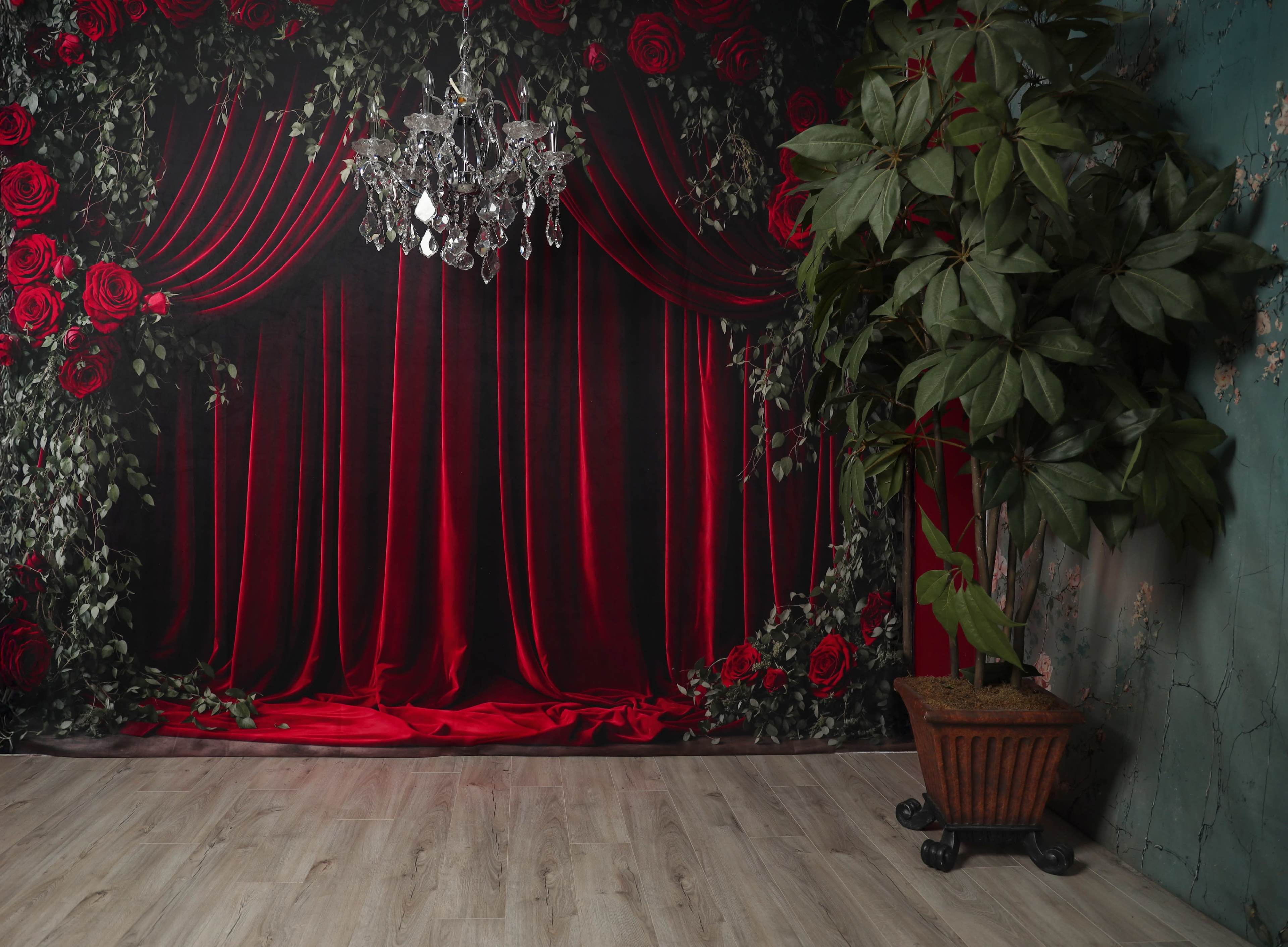 The scene features a red velvet curtain backdrop with a chandelier hanging above and a potted plant in the corner.