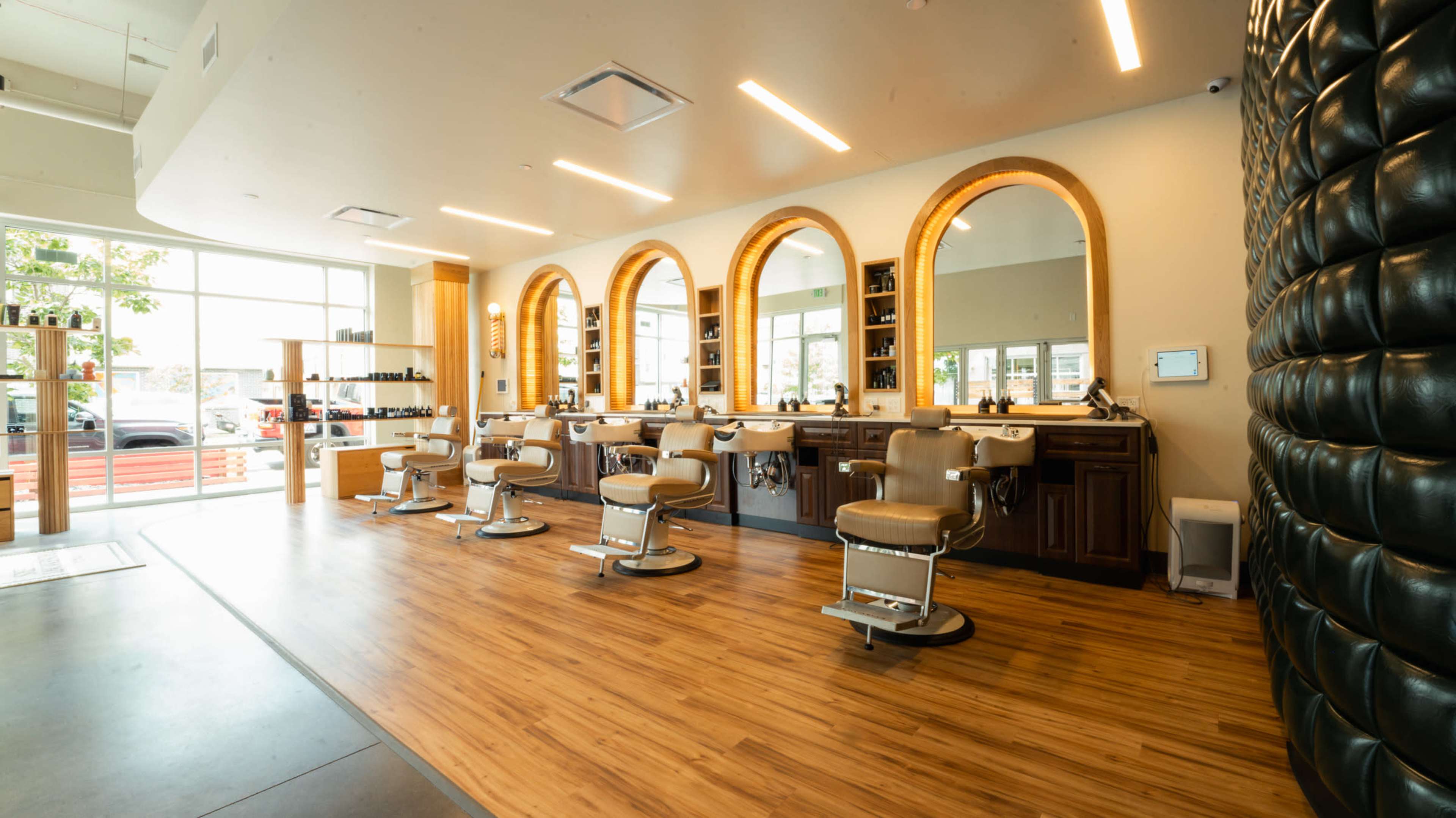 Stylish Barbershop in RiNo — Curved White Wall, Photography Lighting, and Modern Vintage Vibe Image in Five Points, Denver, CO