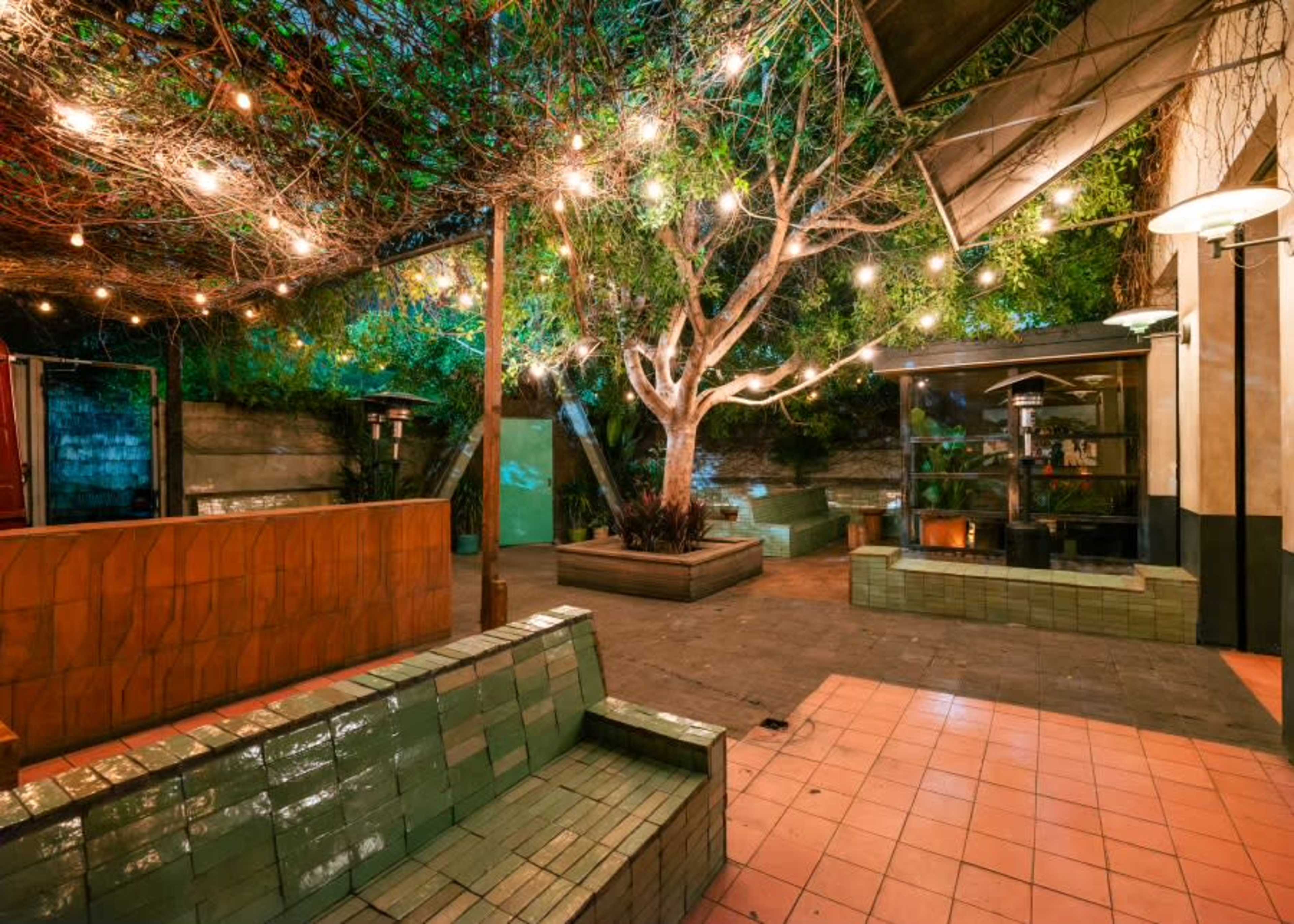 indoor outdoor patio bar with lush greenery and vine trellised canopy Image in Silver Lake, los angeles, CA
