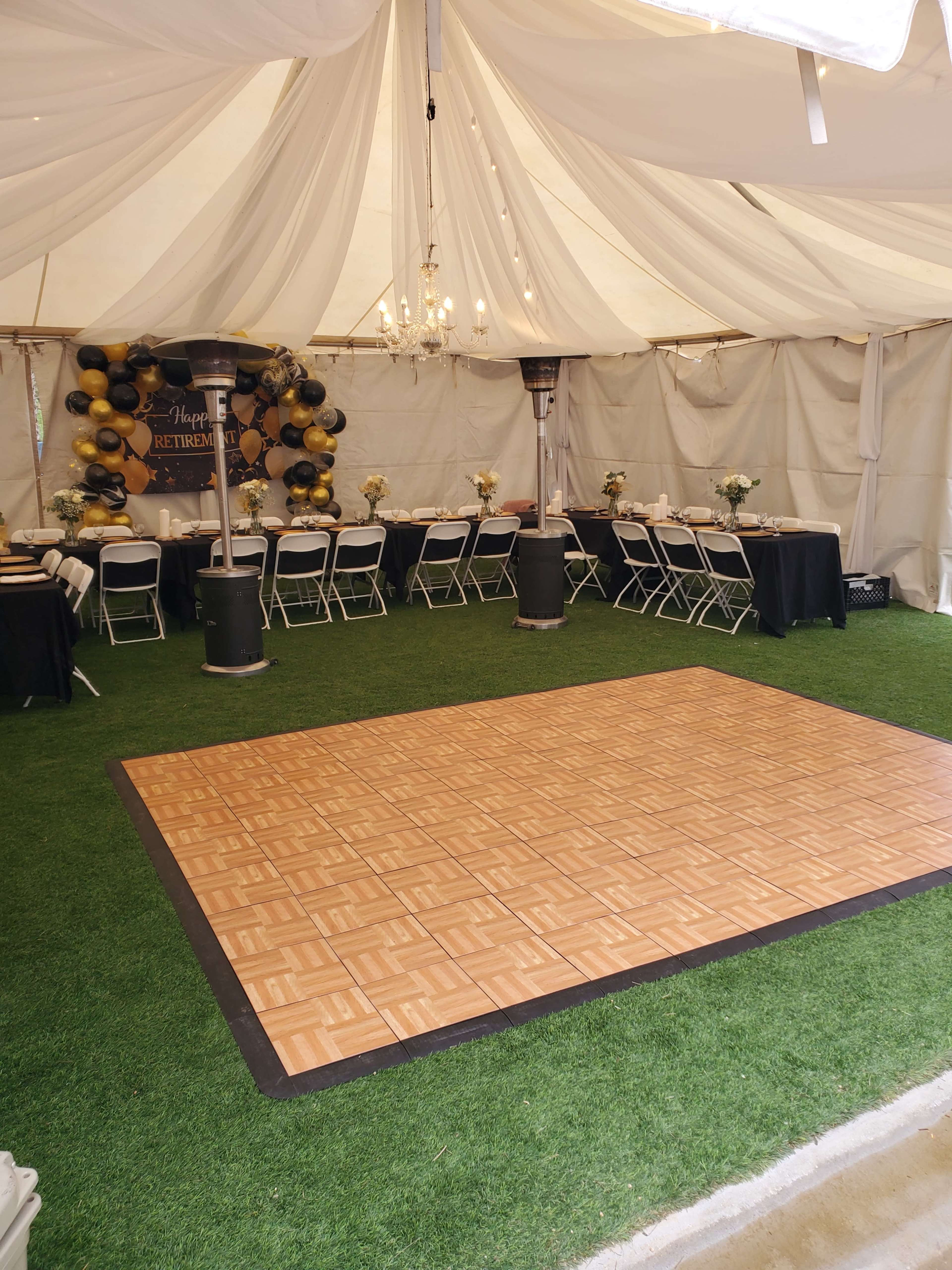 The image shows a decorated indoor tent with a dance floor in the center, surrounded by tables set for a retirement party.