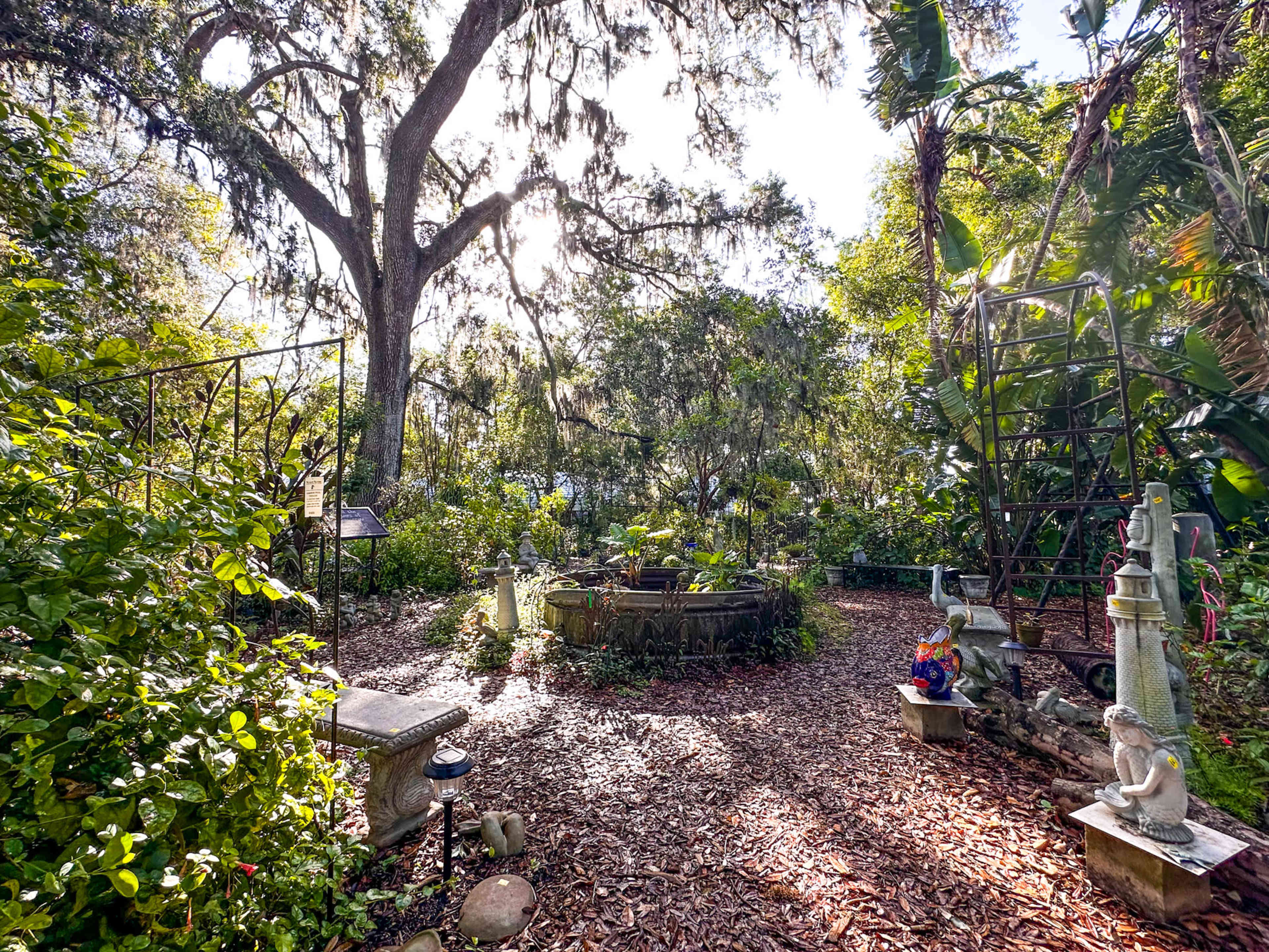 Whimsical Garden Venue with Greenhouse, Sculptures, and Meandering Pathways Image in East County Civic Group, Plant City, FL