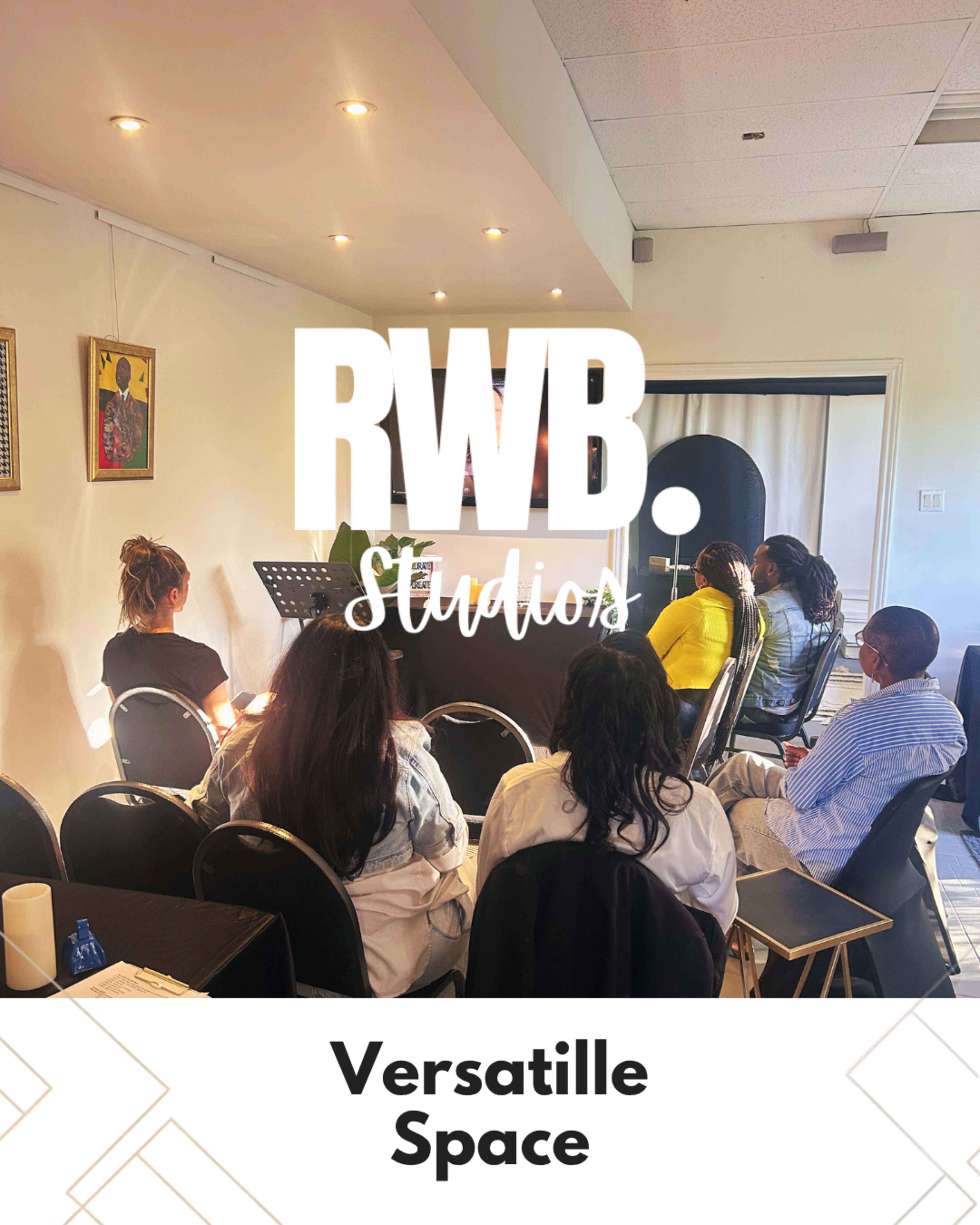 A group of people is seated in a well-lit room, listening attentively to a presentation at RWB Studios, labeled as "Versatile Space."