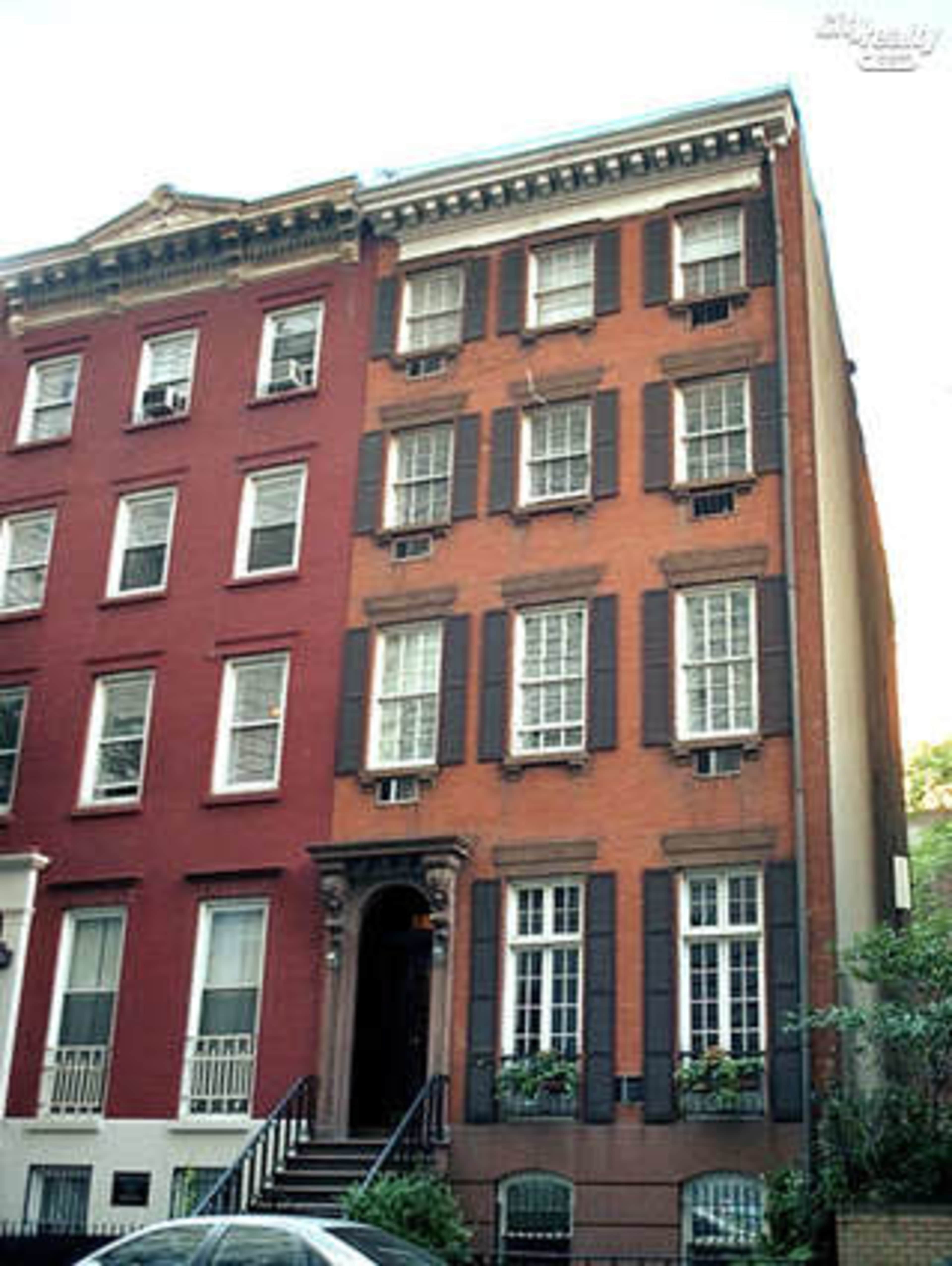 The image shows a row of three buildings, featuring a red brick structure with dark shutters on the right side and a brownstone building with decorative trim on the left.