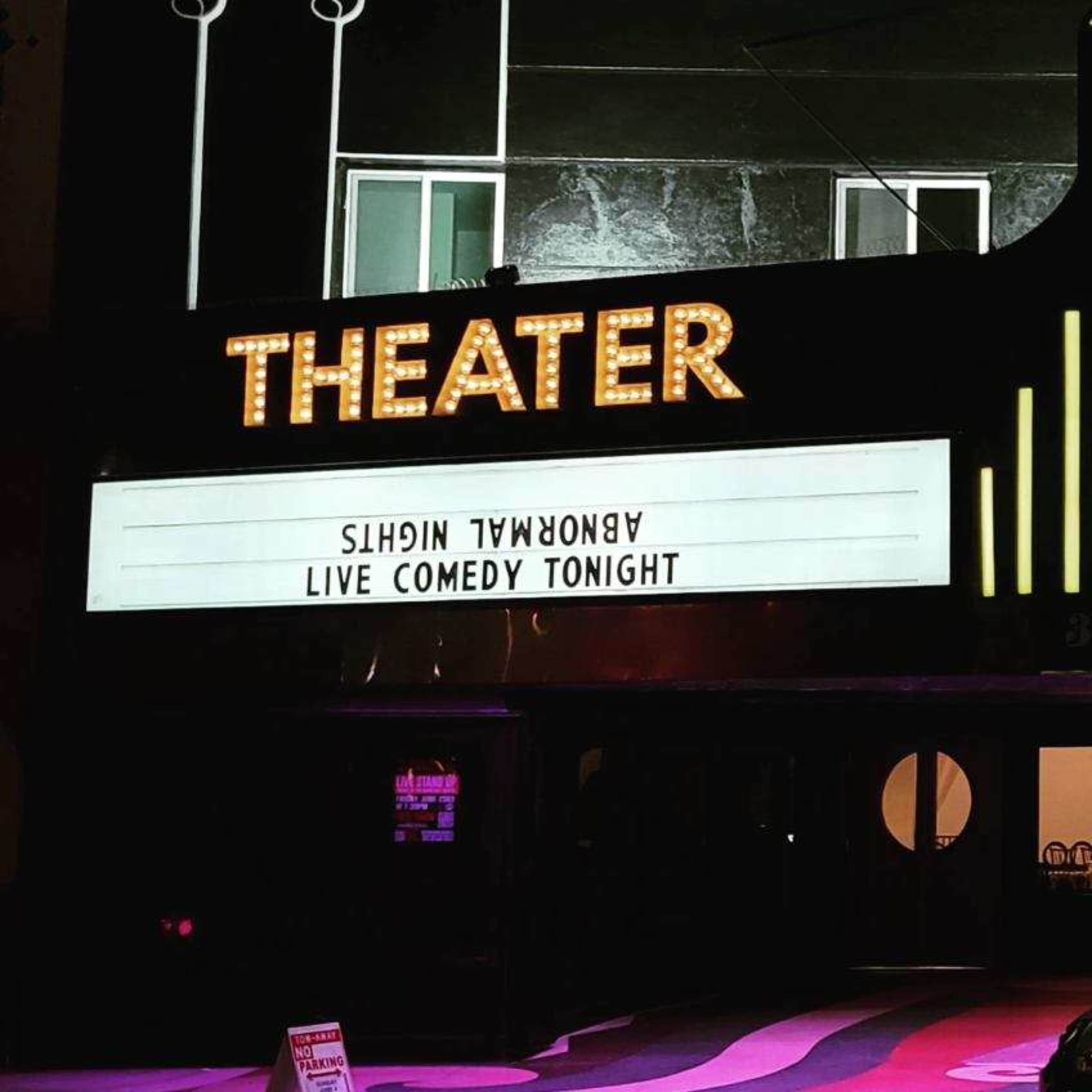 The marquee of a theater displays the message "LIVE COMEDY TONIGHT."
