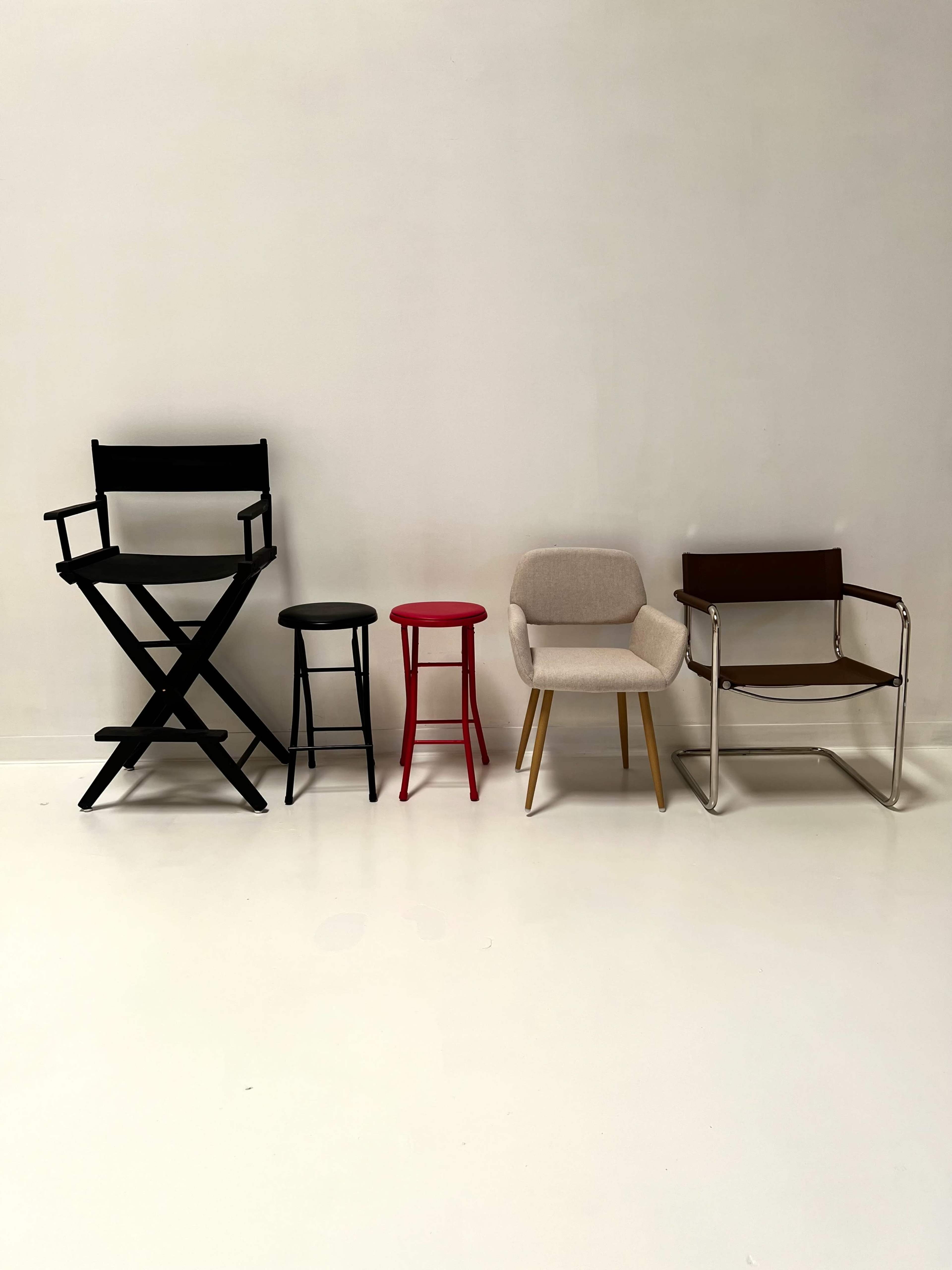 The image shows five different types of chairs arranged in a row against a plain, light-colored background.