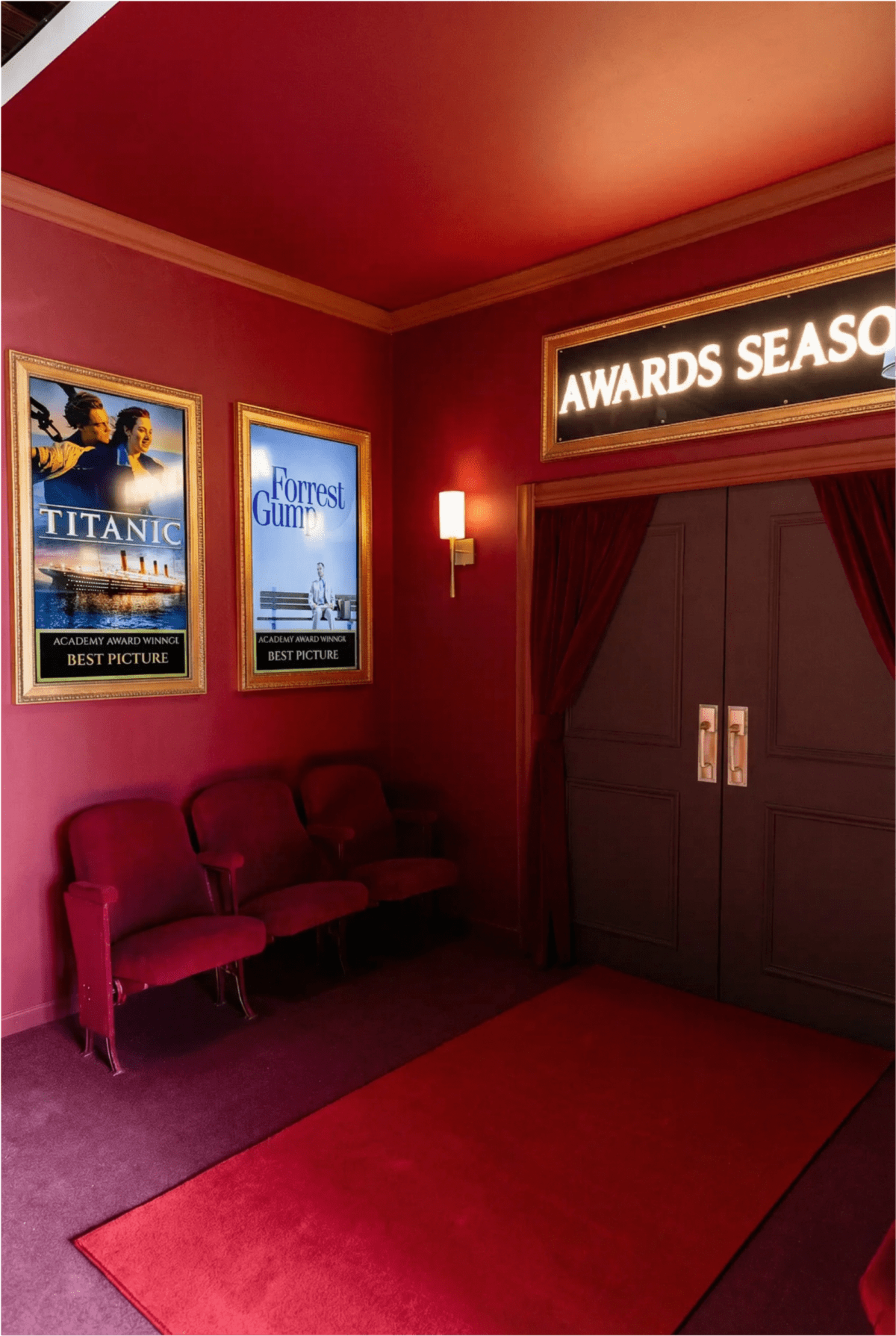 The image shows a dimly lit hallway adorned with movie posters for "Titanic" and "Forrest Gump," leading to a pair of closed doors marked "Awards Season."