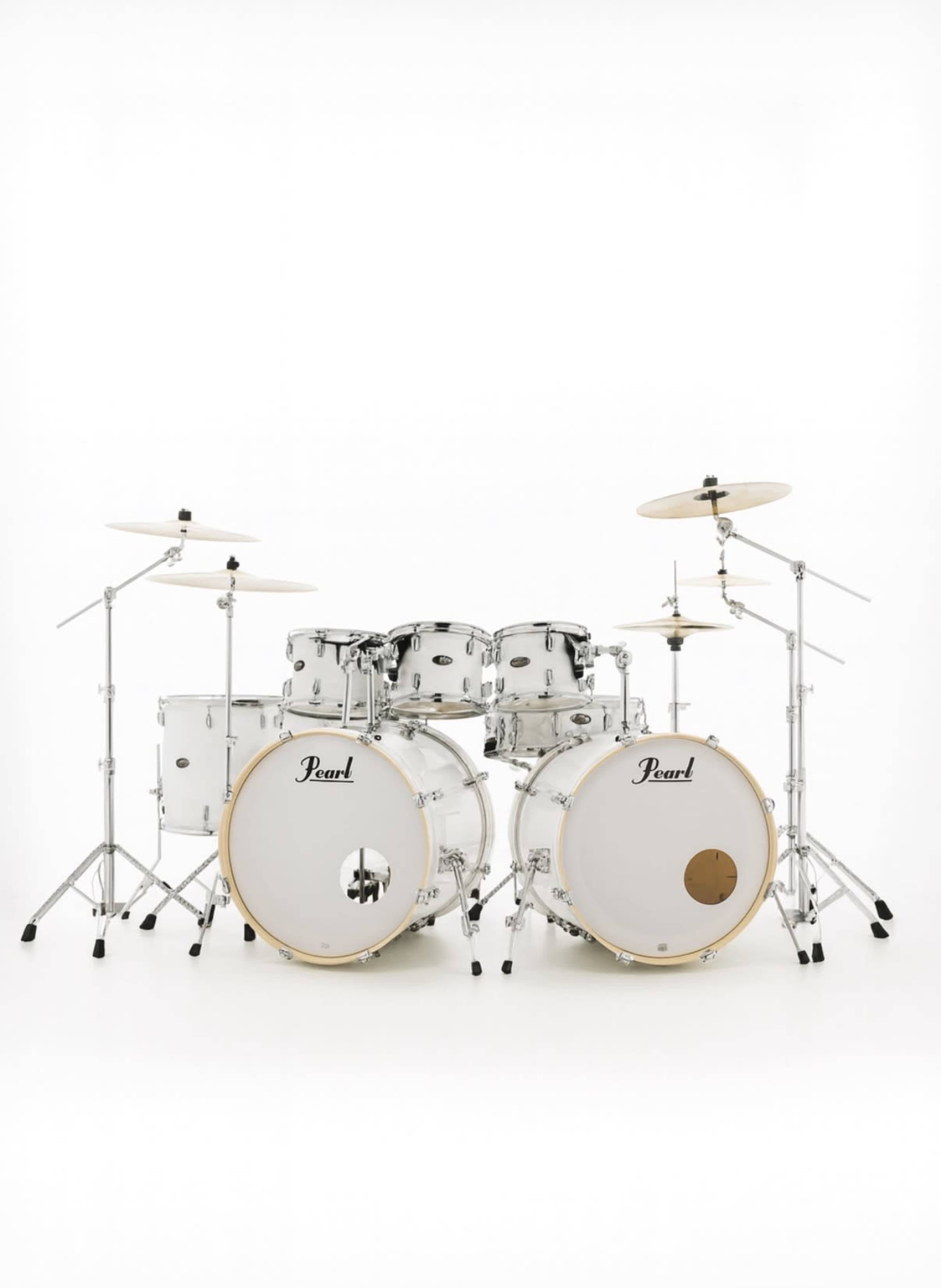 The image displays a white Pearl drum set featuring two bass drums, multiple toms, and cymbals arranged on stands.