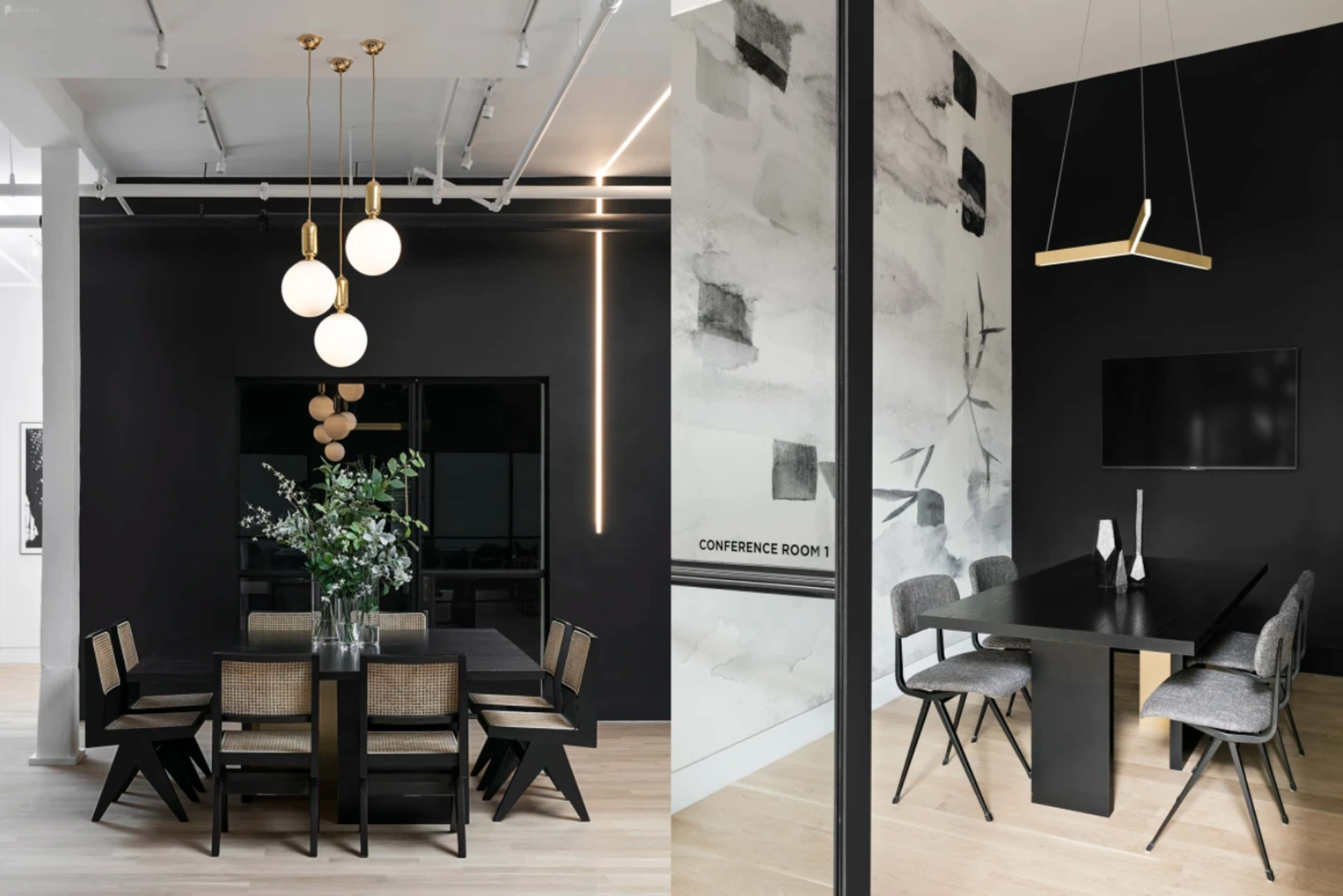 A modern dining area on the left with a dark table and chairs under pendant lights, and a conference room on the right featuring a long black table with chairs and a wall adorned with abstract art.