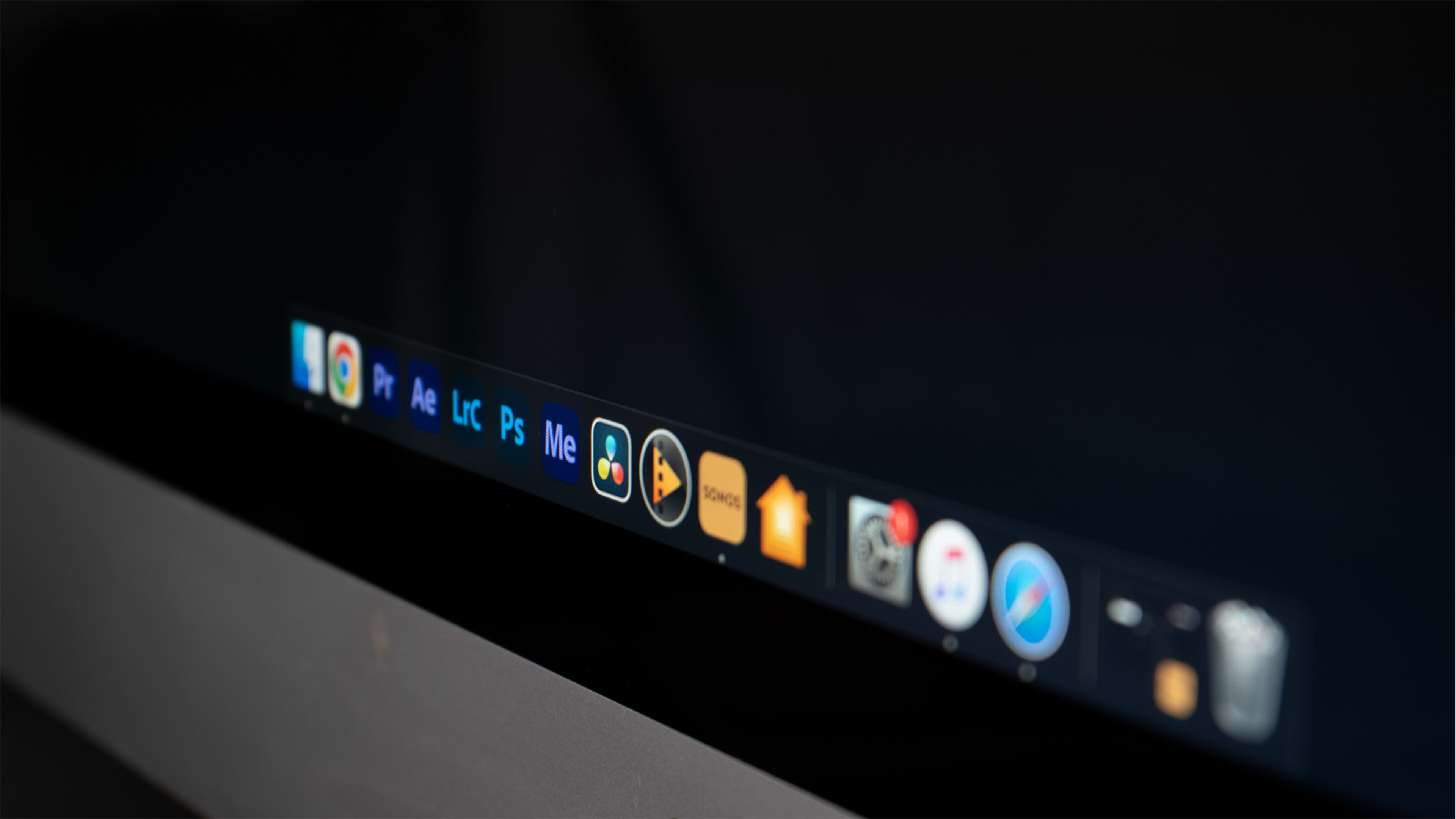 A close-up of a computer screen displaying various application icons on the taskbar.
