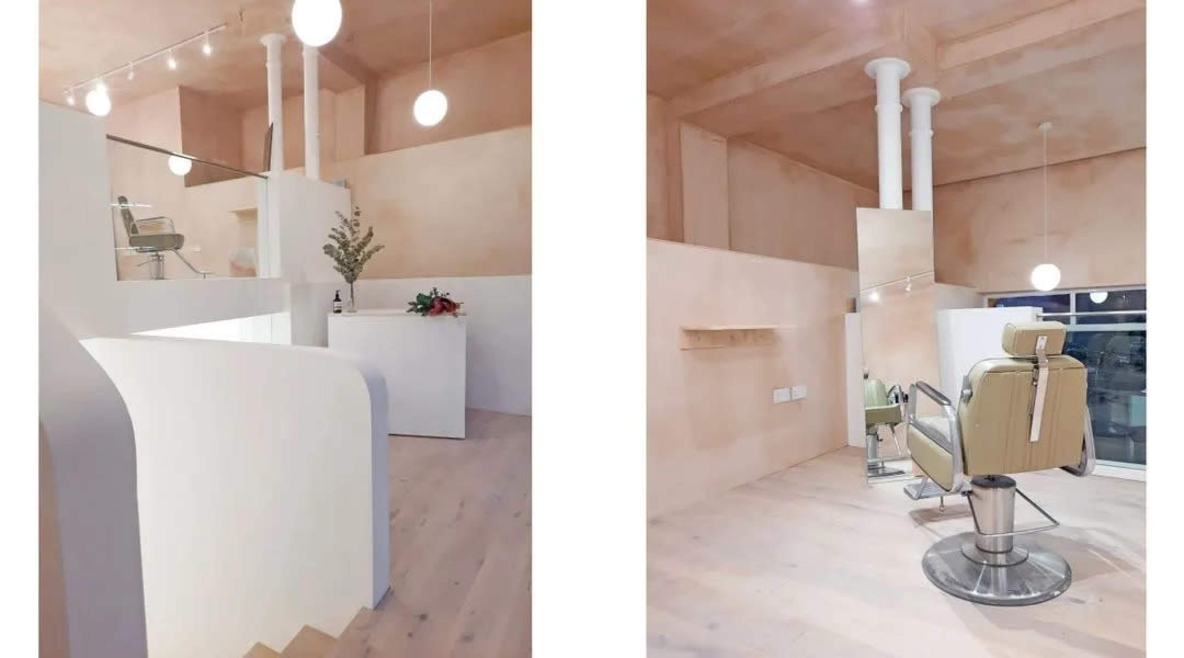 The image shows a modern salon interior featuring a light-colored space with a styling chair and minimalist decor.