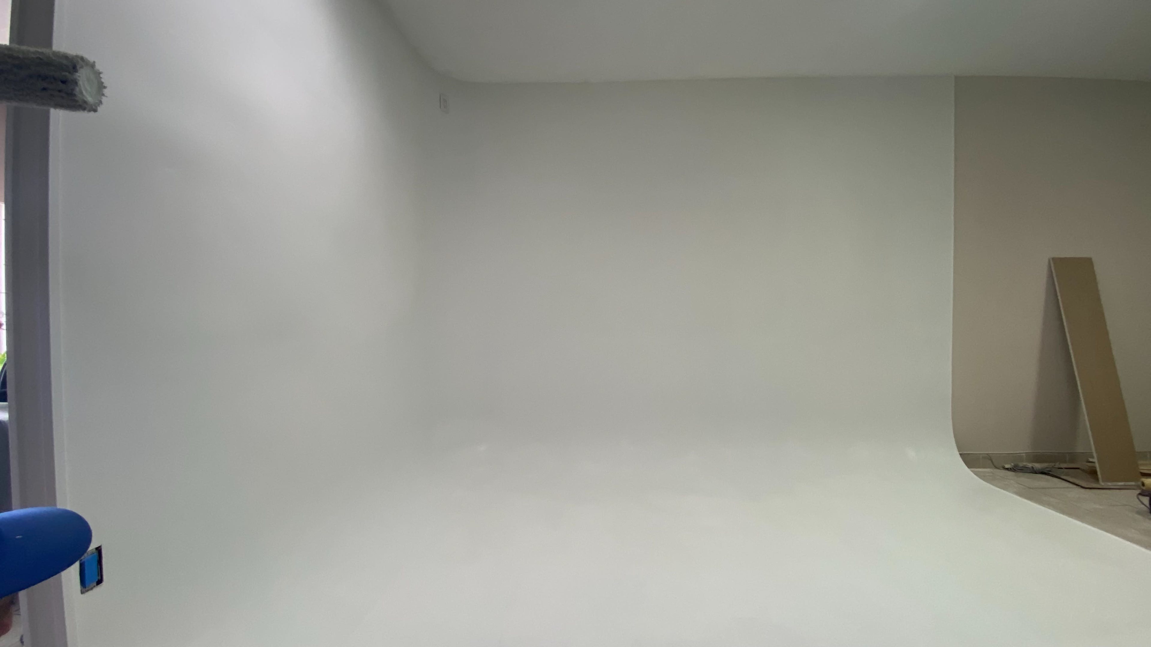 A blank, white studio space with smooth walls and a clean floor.
