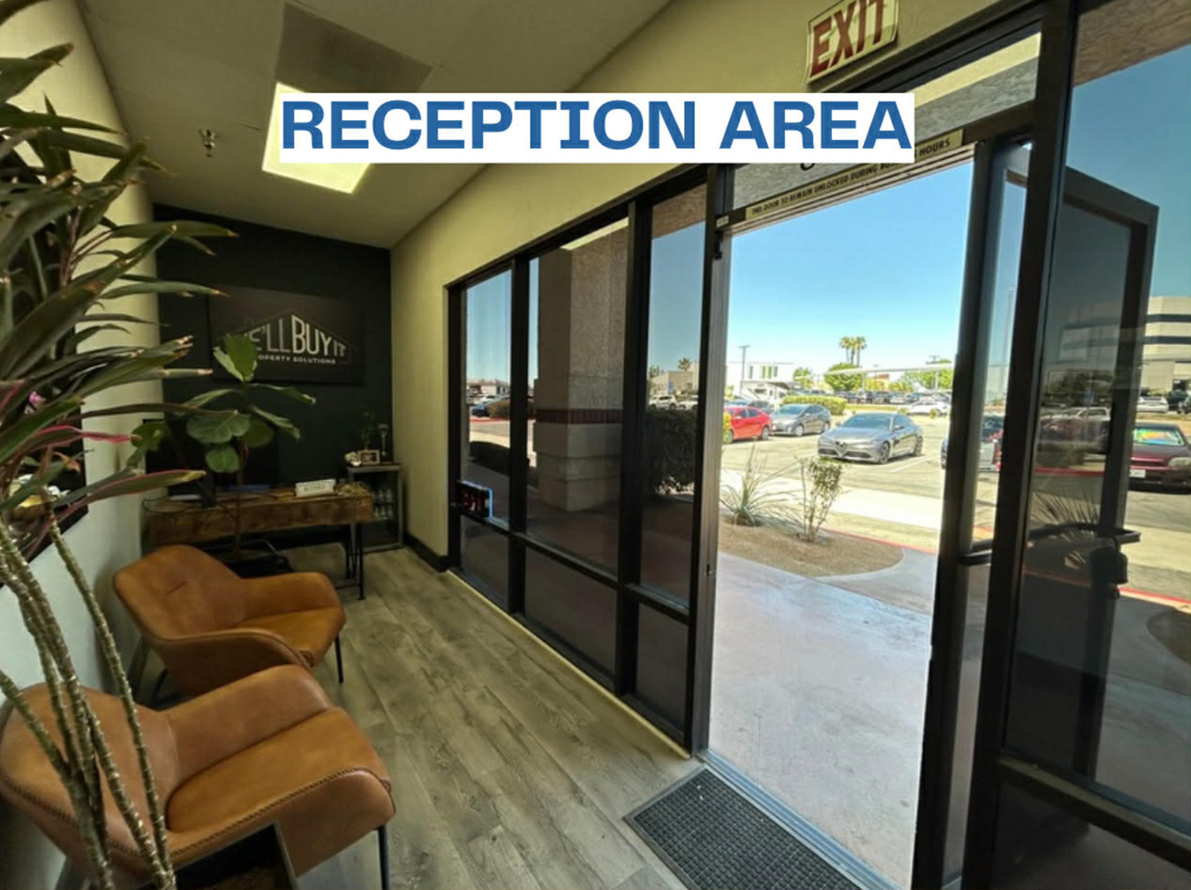 The image shows a reception area with two chairs, a desk, and a glass door leading outside.